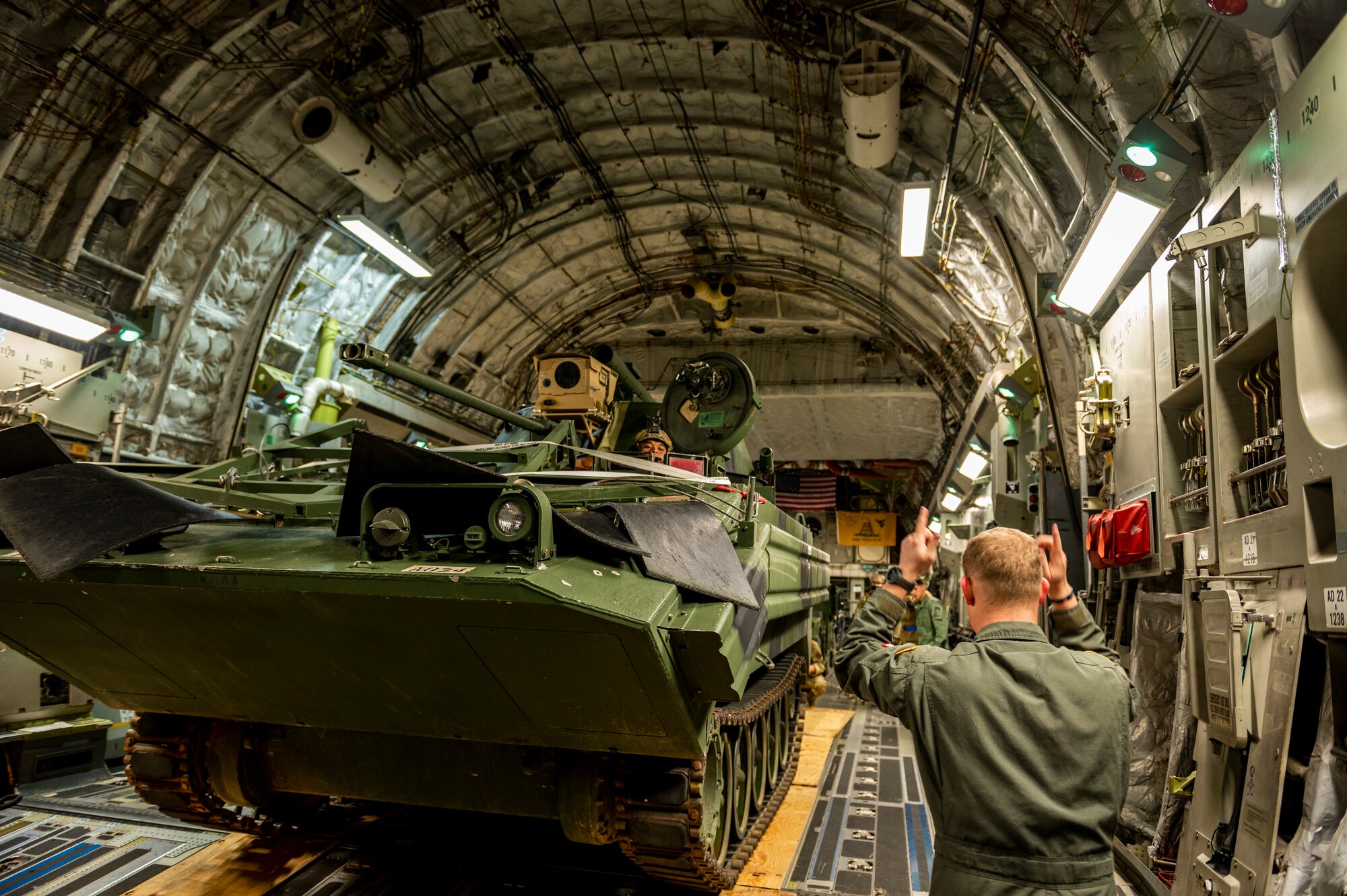 U.S. Air Force Staff Sgt. David Landis, a loadmaster with the 167th Airlift Squadron, guides a modified M113 armored personnel carrier onto a 167th C-17 Globemaster III aircraft during exercise Green Flag Little Rock 22-03 at Alexandria International Airport, Louisiana, Jan. 10, 2022. GFLR 22-03 focused on three joint-accredited items: combat airlift; survival, evasion, resistance and escape; and aeromedical evacuation.