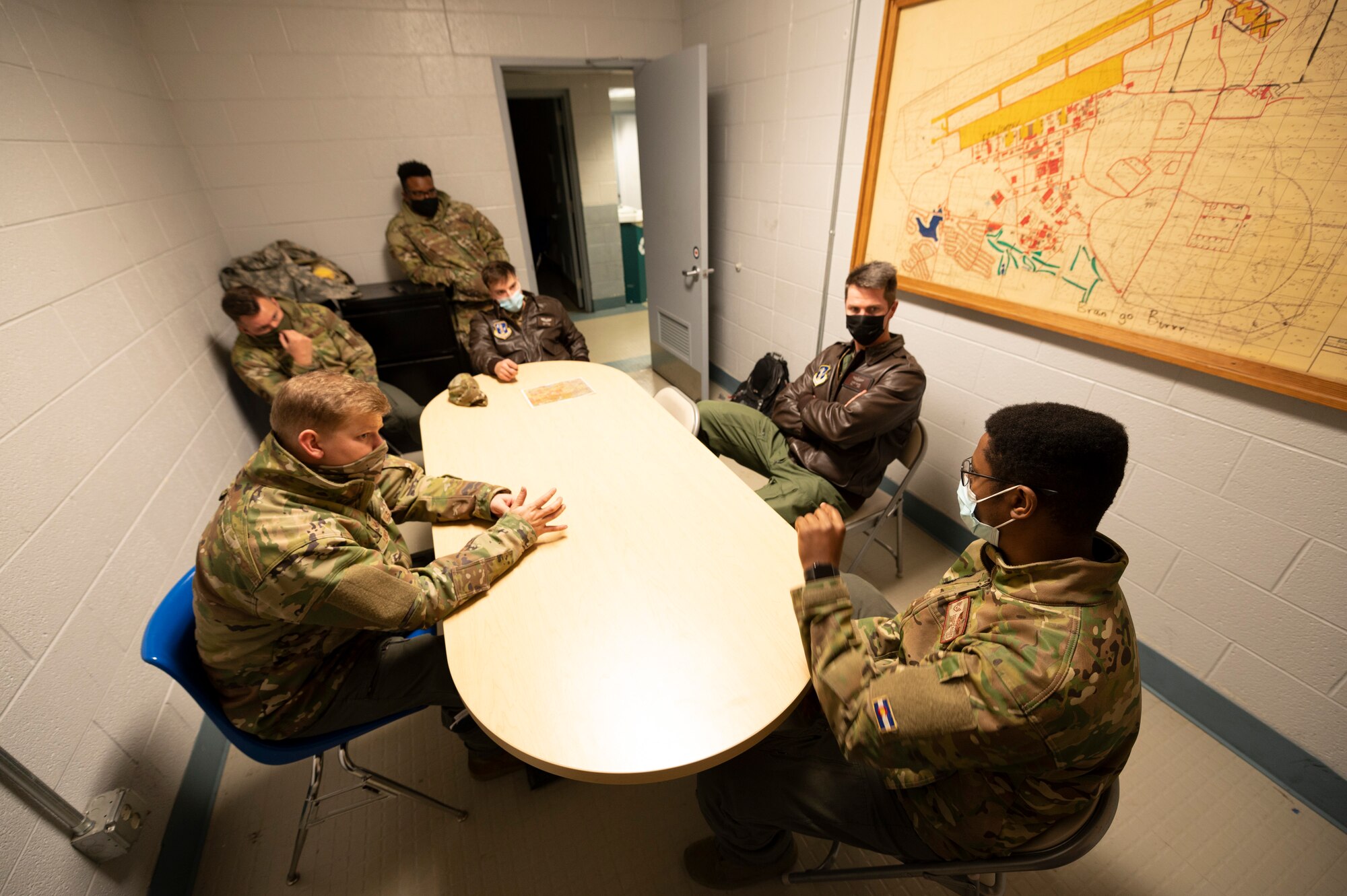 U.S. Air Force Staff Sgt. Deondre Rogers, right, a loadmaster with the 41st Airlift Squadron, Little Rock, Arkansas, debriefs with a 167th Airlift Wing aircrew during exercise Green Flag Little Rock 22-03 at Little Rock Air Force Base, Jacksonville, Arkansas, Jan. 11, 2022. GFLR 22-03 focused on three joint-accredited items: combat airlift; survival, evasion, resistance and escape; and aeromedical evacuation.