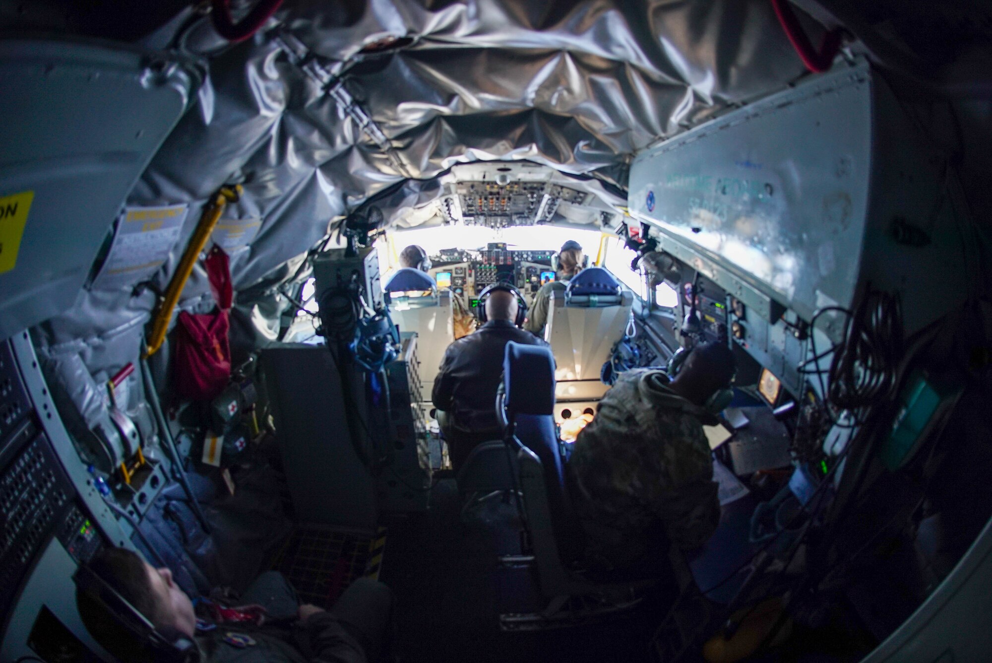 Airmen from the 54th Air Refueling Squadron and 97th Training Squadron sit in the cockpit of a KC-135 Stratotanker near Eglin Air Force Base, Florida, Feb. 5, 2022. Throughout their mission, both pilots and boom operators were able to continue their usual training, but also gain experience with ACE concepts. (U.S. Air Force photo by Airman 1st Class Trenton Jancze)