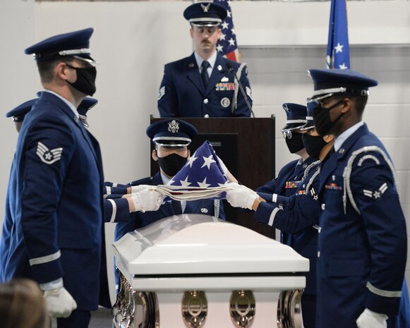 Air Force Ceremonial Guardsmen demonstrate the six-man flag fold over a casket during the graduation ceremony of 28 new Ceremonial Guardsmen at Wright-Patterson Air Force Base, Ohio on April 20, 2021. A 21-gun salute was also included before graduates received their Honor Guard Badges. (U.S. Air Force photo by Ty Greenlees)
