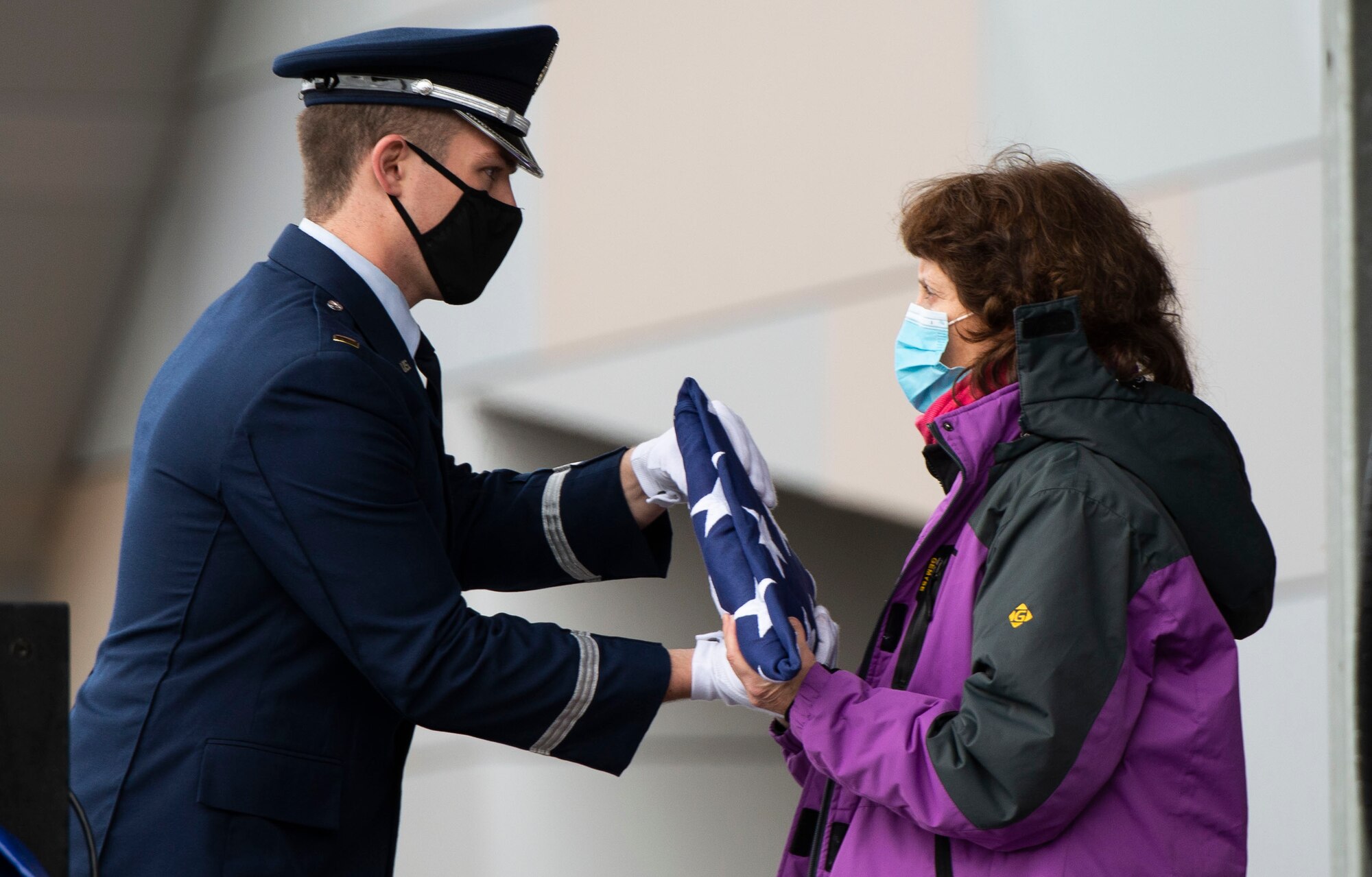 A ceremonial guardsman from Wright-Patterson Air Force Base, Ohio, presents the American flag to Victoria Yeager during the “Celebration of Life” service for Retired Brig. Gen. Chuck Yeager at the Charleston Coliseum & Convention Center in Charleston, West Virginia, Jan. 15, 2021. Yeager was an Air Force flying ace and test pilot who in 1947 became the first in history confirmed to have exceeded the speed of sound in level flight. (U.S. Air Force photo by Wesley Farnsworth)