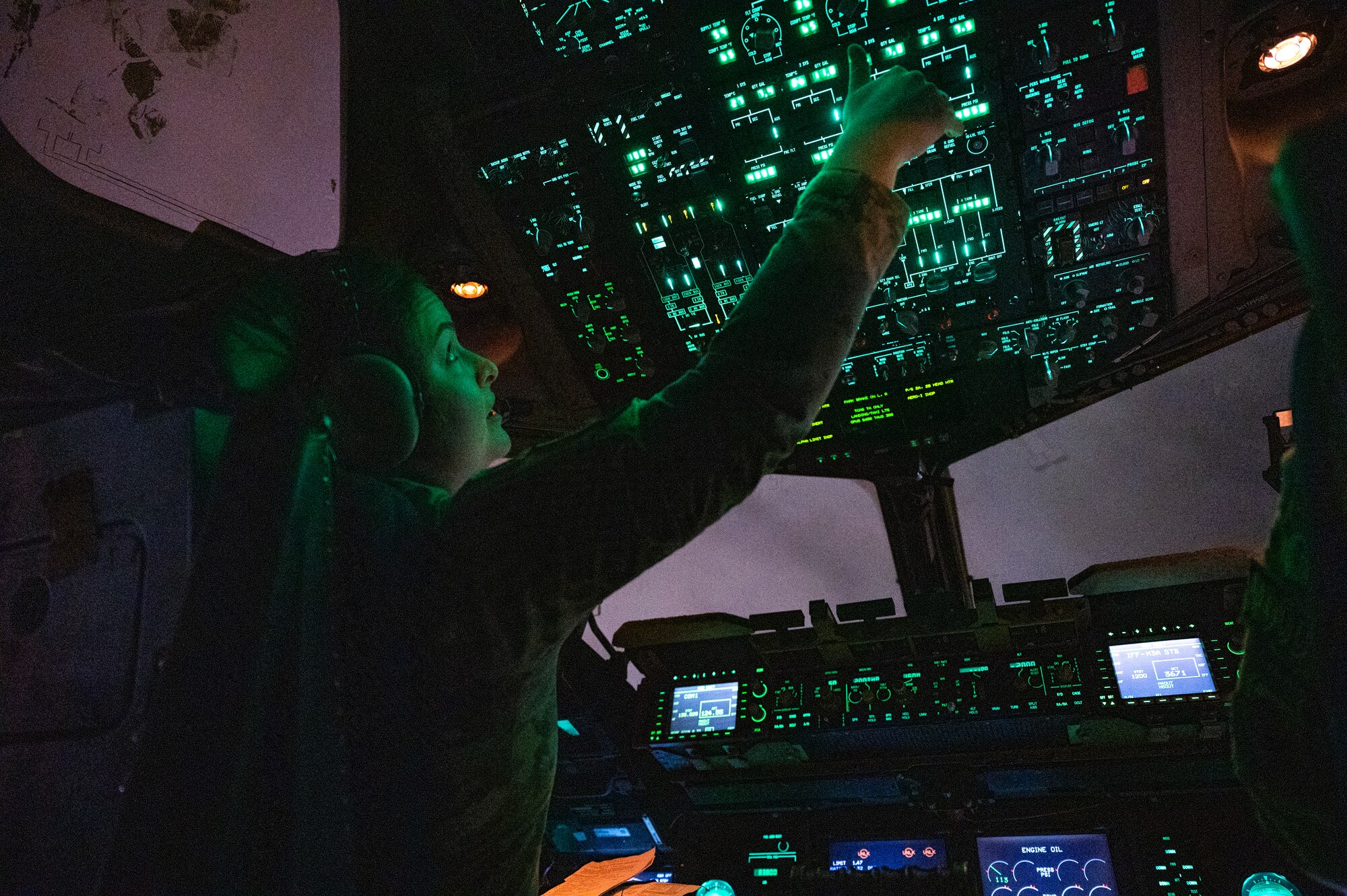 U.S. Air Force Capt. Sierra Kelly, left, a pilot with the 8th Airlift Squadron, and U.S. Air Force Capt. Carol Champion, a pilot with the 16th Airlift Squadron, conduct pre-flight checks prior to takeoff on a C-17 Globemaster III as part of Battalion Mass Tactical Week at Pope Army Airfield, North Carolina, Feb. 4, 2022. During mass-tactical week, Army and Air Force units work together to improve interoperability for worldwide crisis, contingency and humanitarian operations. (U.S. Air Force photo by Airman 1st Class Charles Casner)