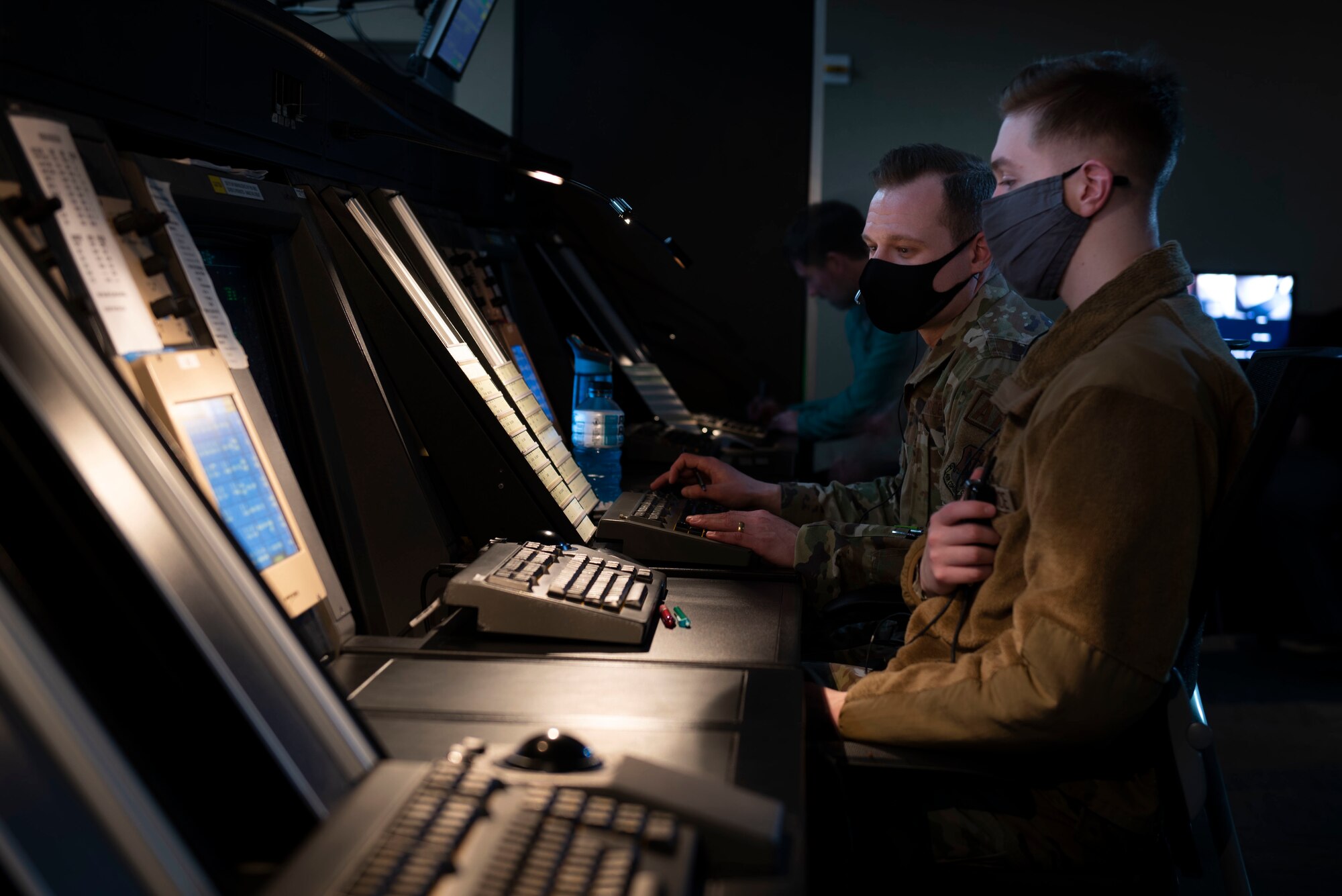 Tech. Sgt. Paul Imm, left, 4th Operations Support Squadron NCO in charge of standardization and evacuation, and Airman 1st Class Zachary Stoltzmann, 4th OSS air traffic control specialist, monitor flight patterns at Seymour Johnson Air Force Base, North Carolina, Feb. 2, 2022. During emergency situations controllers are able to help aircraft land by checking weather, landing space, and flight patterns. (U.S. Air Force photo by Airman 1st Class Sabrina Fuller)