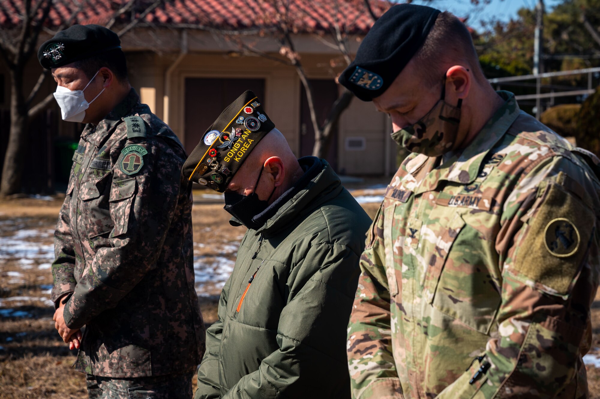 R.O.K. Army Col. Sung Jin Park (left), 3rd Battlefield Coordination Detachment-Korea commander, Earnest Lee, Korean War veteran and Hill 180 remembrance ceremony distinguished guest (center) and U.S. Army Col. Jeffrey Munn, 3rd Battlefield Coordination Detachment-Korea commander, bow their heads for a moment of silence