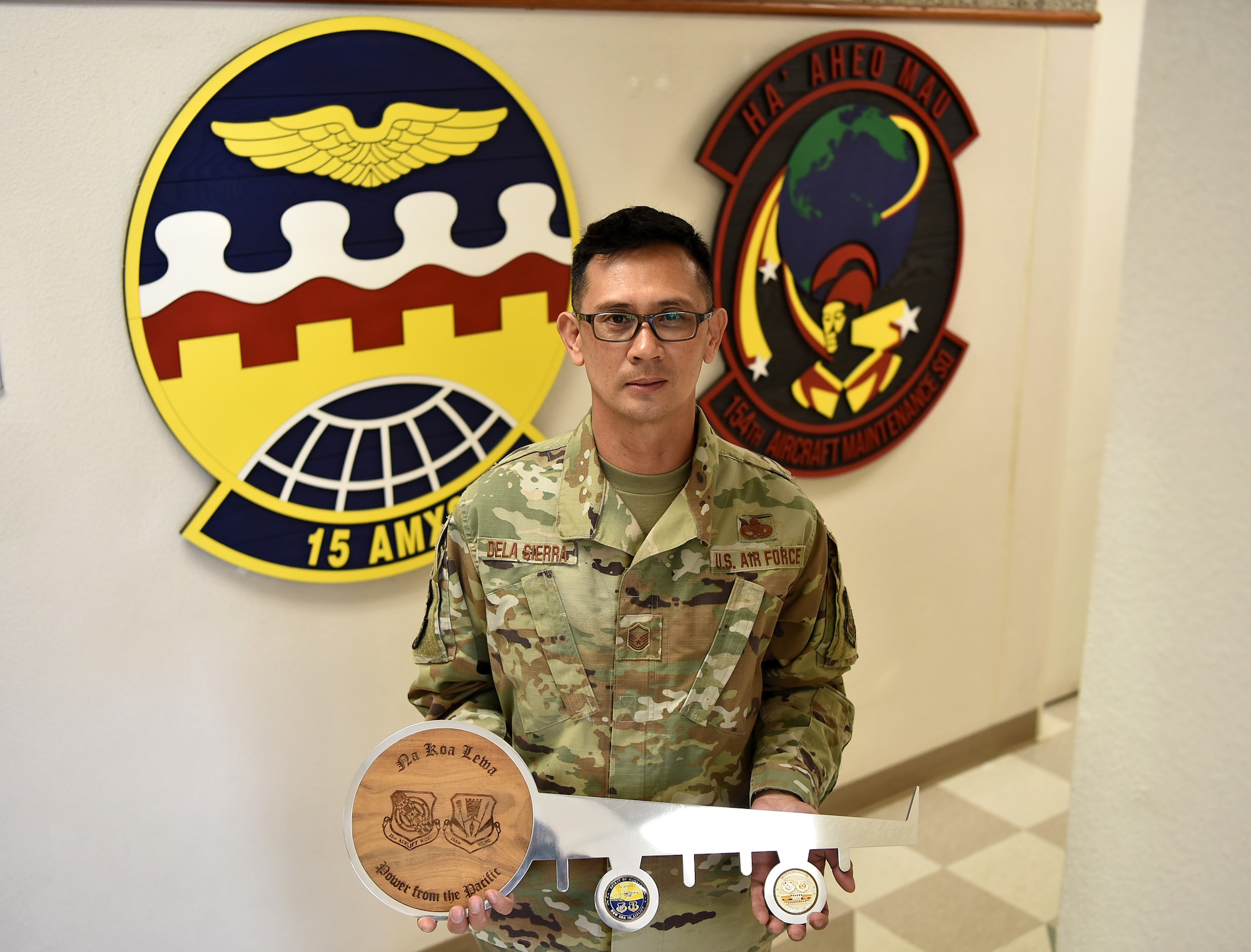 U.S. Air Force Master Sgt. Rafeal Dela Sierra, 154th Aircraft Maintenance Squadron dedicated crew chief, holds the key to the first Hawai’i based C-17 Globemaster III on the 16th anniversary of its arrival to Joint Base Pearl Harbor-Hickam, Hawaii, Feb. 8, 2022. Dela Sierra was part of the original crew members that marshaled the C-17 onto Hickam’s flightline. (U.S. Air Force photo by Tech. Sgt. Anthony Nelson Jr.)