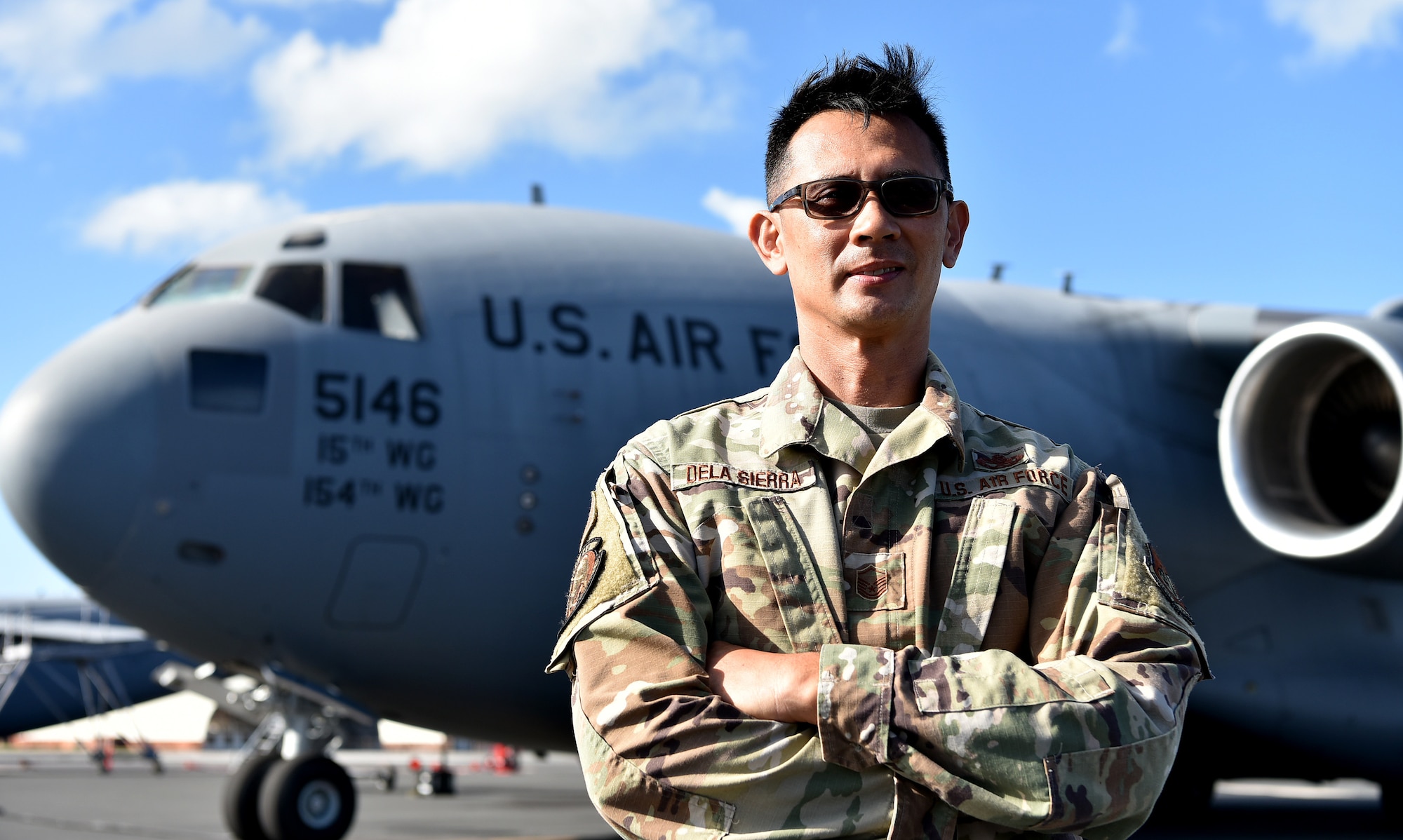 U.S. Air Force Master Sgt. Rafeal Dela Sierra, 154th Aircraft Maintenance Squadron dedicated crew chief, reminisces about the arrival of the first Hawai’i based C-17 Globemaster III on the 16th anniversary of its arrival to Joint Base Pearl Harbor-Hickam, Hawaii, Feb. 8, 2022. Dela Sierra served on the original aircraft maintenance crew that marshaled the first C-17 to then Hickam Air Force Base.   (U.S. Air Force photo by Tech. Sgt. Anthony Nelson Jr.)
