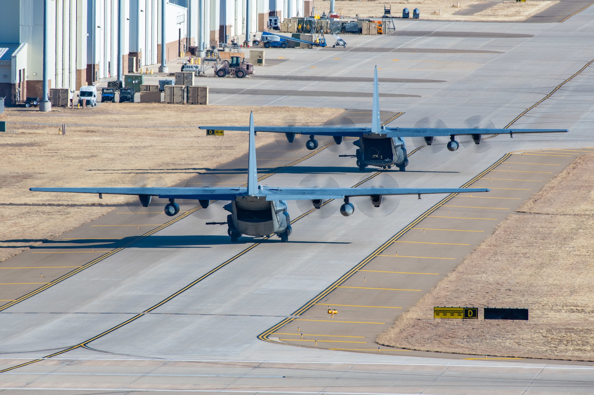 Two AC-130 Stinger II gunships assigned to the 16th Special Operations Squadron taxi on the Cannon Air Force Base, New Mexico, after conducting a Spirit 03 memorial flyover of the base Jan. 31, 2022. Spirit 03 is the last U.S. Air Force gunship to date that has been lost in combat. (U.S. Air Force photo by Staff Sgt. Maxwell J. Daigle)