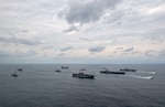 Ships of the America and Essex Amphibious Ready Groups, and Carrier Strike Group 3, sail in formation with the Japan Maritime Self-Defense Force during exercise Noble Fusion. Left to right: USS Dewey (DDG 105), USS Ashland (LSD 48), JS Kongō (DDG 173), USS Miguel Keith (ESB 5), USS America (LHA 6), USS Mobile Bay (CG 53), USS Abraham Lincoln (CVN 72), USS Spruance (DDG 111), USS Essex (LHD 2), landing crafts, air cushion from Assault Craft Unit (ACU) 5. Noble Fusion demonstrates that Navy and Marine Corps forward-deployed stand-in naval expeditionary forces can rapidly aggregate Marine Expeditionary Unit/Amphibious Ready Group teams at sea, along with a carrier strike group, as well as other joint force elements and allies, in order to conduct lethal sea-denial operations, seize key maritime terrain, guarantee freedom of movement, and create advantage for U.S., partner and allied forces. Naval Expeditionary forces conduct training throughout the year, in the Indo-Pacific, to maintain readiness.