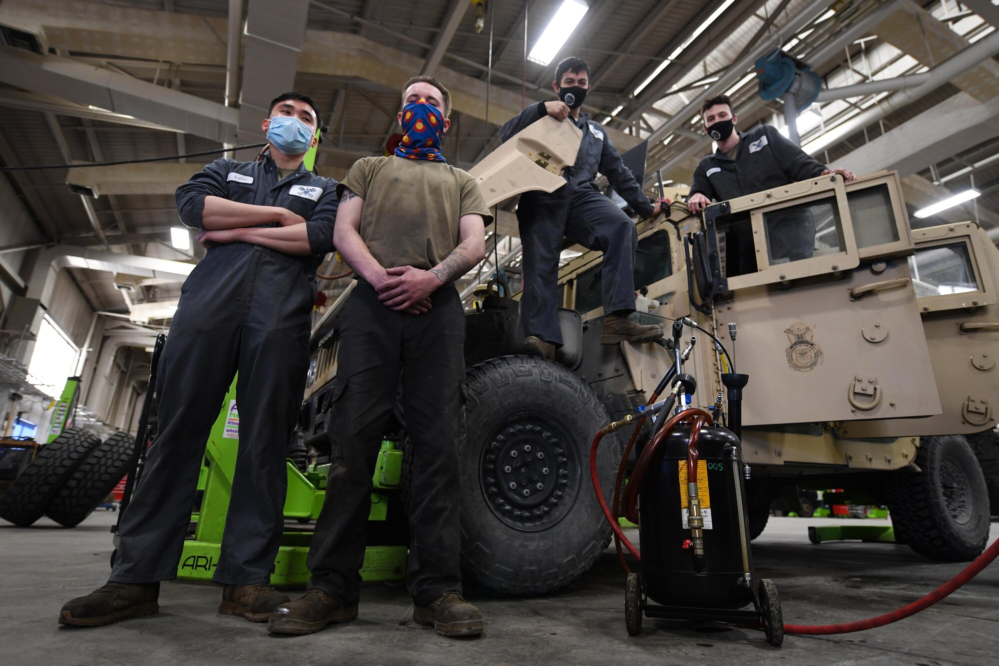 Airmen from the 90th Logistics Squadron pose with a Humvee at the 90 LRS Vehicle Maintenance Flight warehouse on F.E. Warren Air Force Base, Wyoming, Feb. 8, 2022. The Vehicle Maintenance Flight is responsible for maintaining and repairing vehicles operated on base to be used in the mission of strategic nuclear deterrence. (U.S. Air Force photo by Airman 1st Class Charles Munoz)