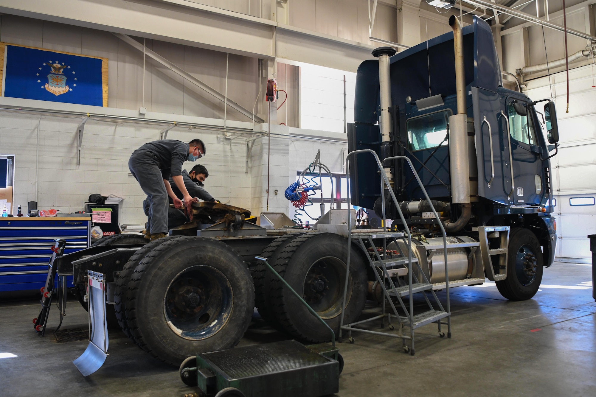 Airman 1st Class An Luu, vehicle mechanic (left), and Airman 1st Class Indigo Schultz, mission generation vehicular equipment maintenance technician, both at the 90th Logistics Squadron, work on a Payload Transporter III at the 90 LRS Vehicle Maintenance Flight warehouse on F.E. Warren Air Force Base, Wyoming, Feb. 8, 2022. The PT III provides the ability to load, unload, transport, emplace, or remove and replace Minuteman weapon system aerospace vehicle equipment and supporting equipment in a controlled environment on air-cushioned pallets between the Minuteman launch facility and the missile support base. (U.S. Air Force photo by Airman 1st Class Charles Munoz)