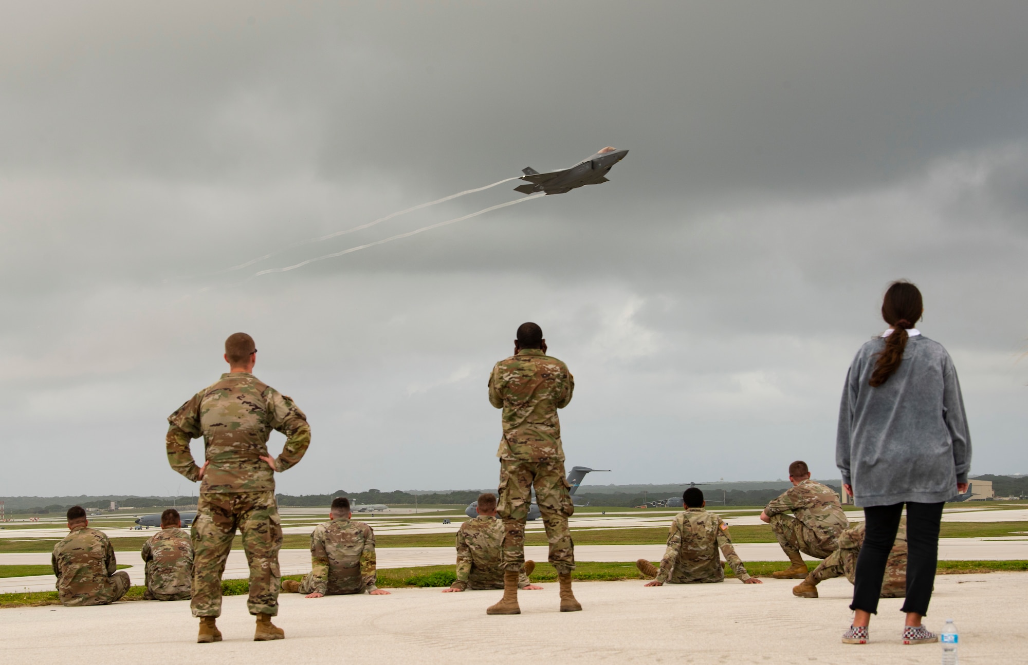 Members from Team Andersen watch a U.S. Air Force F-35A Lightning II Exercise take off from Andersen Air Force Base, Guam, during a take-off viewing day for exercise Cope North 22, Feb. 9, 2022. Service members, their families and civic leaders were invited to the flight line to learn the importance of Cope North while observing aircraft capabilities.  Exercise Cope North is the U.S. Pacific Air Forces’ largest multilateral exercise and includes more than 2, 500 U.S. Airmen, Marines, and Sailors working alongside 1,000 combined Japan Air Self-Defense Force and Royal Australian Air Force counterparts.