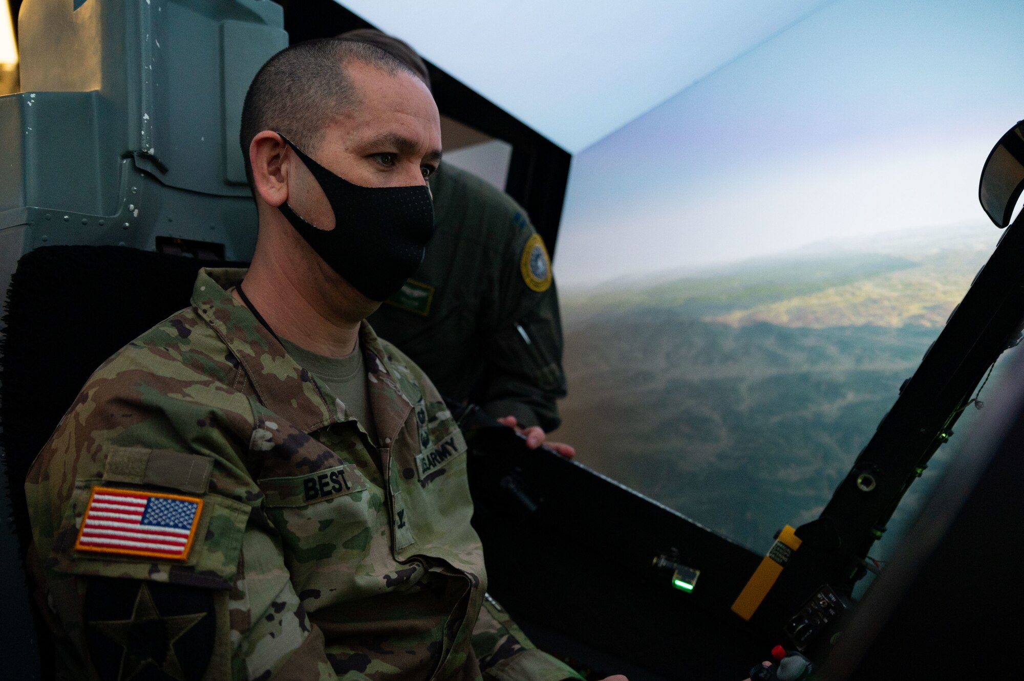 U.S. Army Col. John Best, United States Forces Korea deputy chief of staff, learns flight maneuvers in an A-10 Thunderbolt II simulator during Airpower Immersion Day at Osan Air Base, Republic of Korea, February 11, 2022. He was amongst several sister service member leaders who spent the day learning about the Seventh Air Force mission. (U.S. Air Force photo by Senior Airman Megan Estrada)