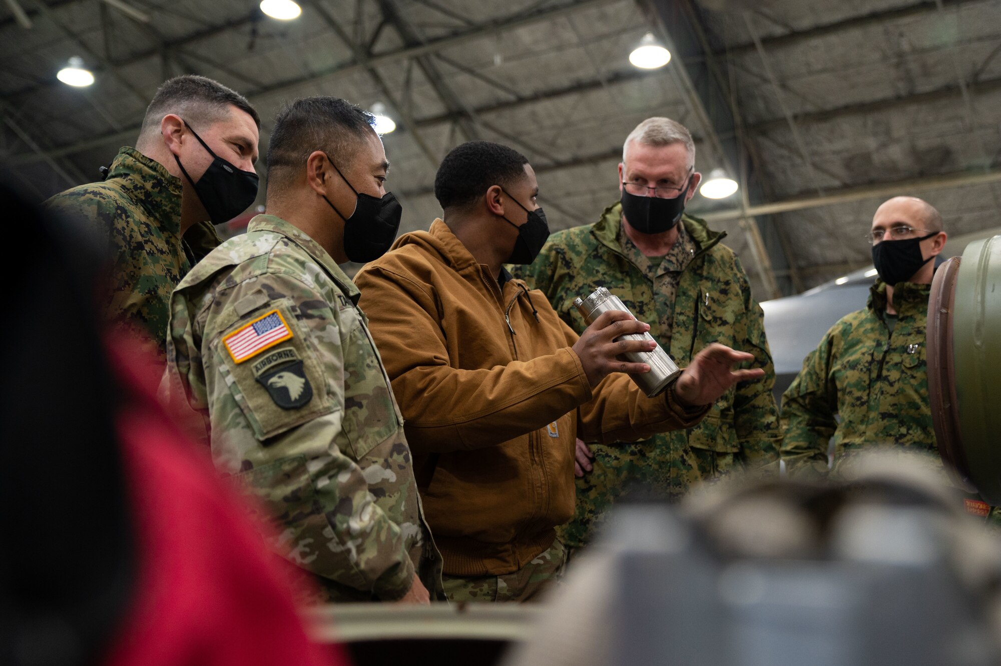 An Airman explains to sister service senior leaders how to assemble an air intercept missile during Airpower Immersion Day at Osan Air Base, Republic of Korea, February 11, 2022. The event also featured stops such as the 607th Air Operations Center and the A-10 and F-16 simulators. (U.S. Air Force photo by Senior Airman Megan Estrada)