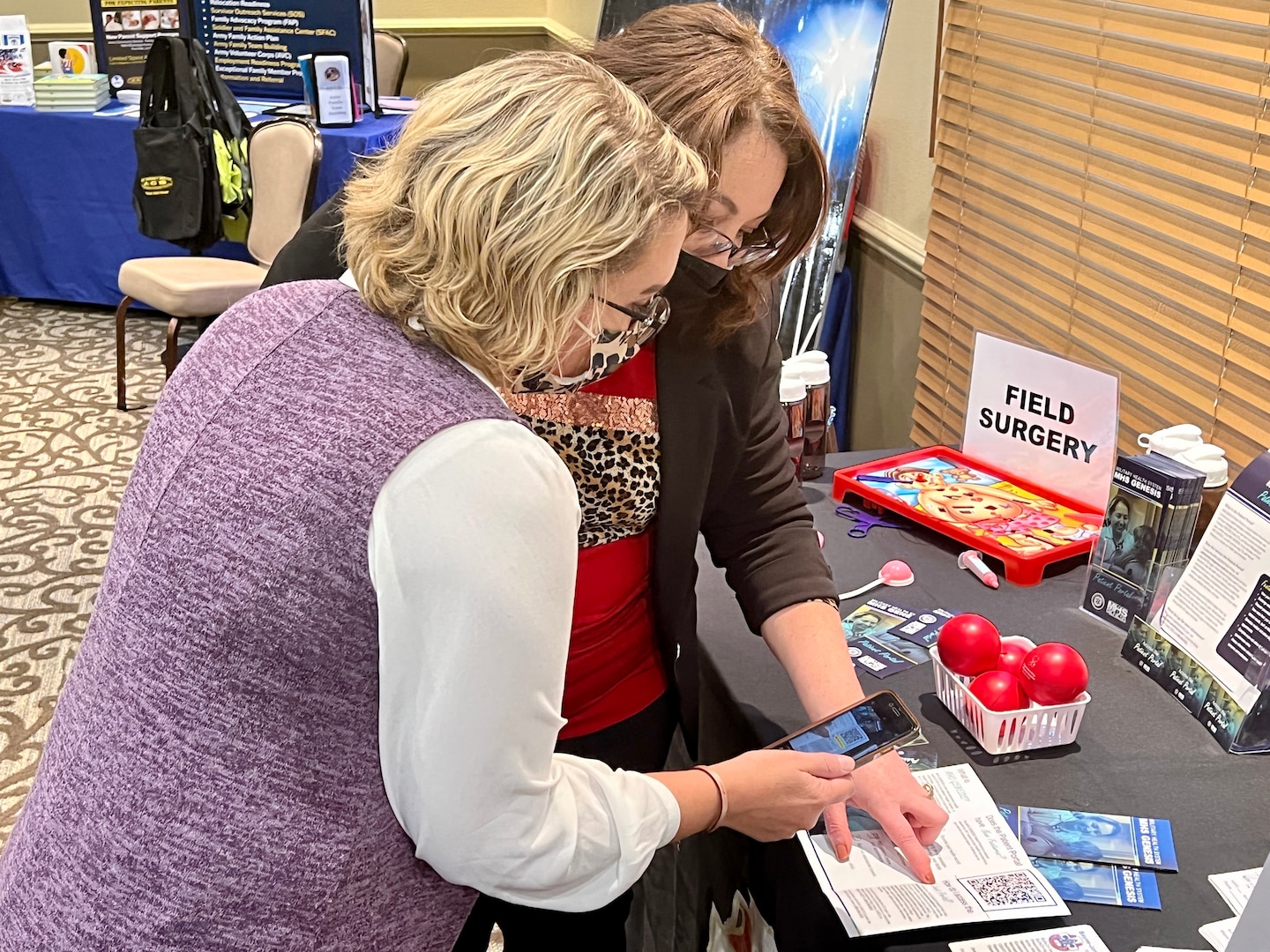 Melissa Box (left), employee of the year for Bayne-Jones Army Community Hospital, discusses the MHS GENESIS patient portal with Jamie Lynn Blum, Fort Polk military spouse of the year nominee, on Feb. 9 at the Joint Readiness Training Center and Fort Polk Quality of Life conference.