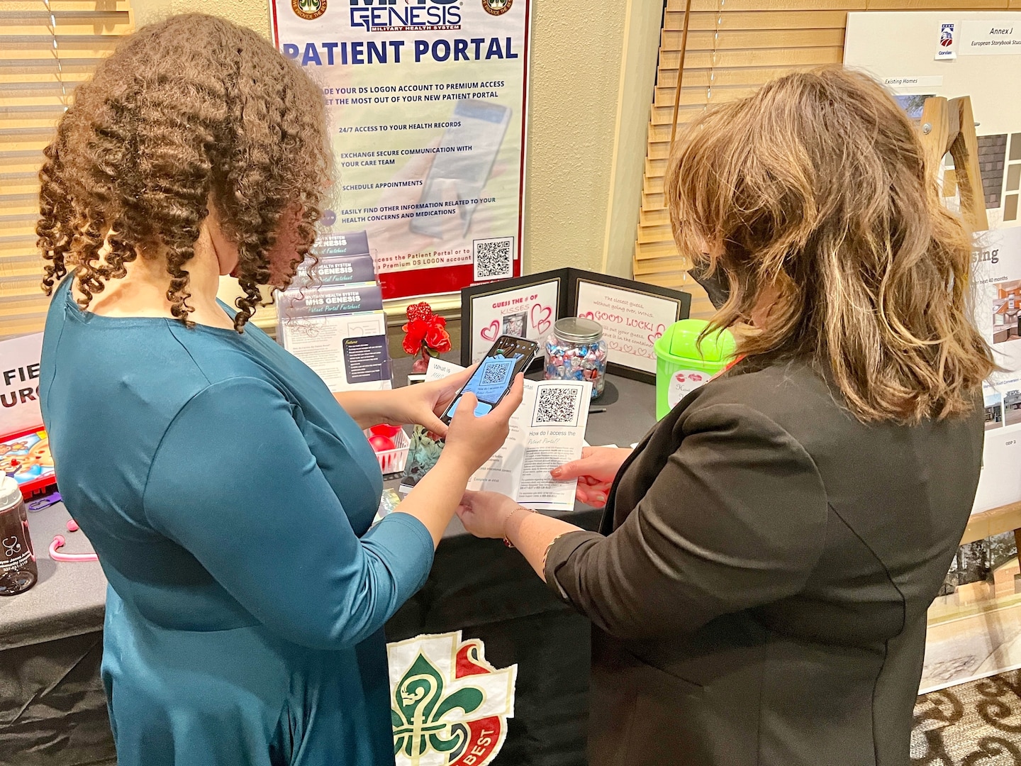 Melissa Box (right), employee of the year for Bayne-Jones Army Community Hospital, explains to Francesca Parent (left) how to register for a free premium access account to the MHS GENESIS Patient Portal on Feb. 9 at the Joint Readiness Training Center and Fort Polk Quality of Life conference.