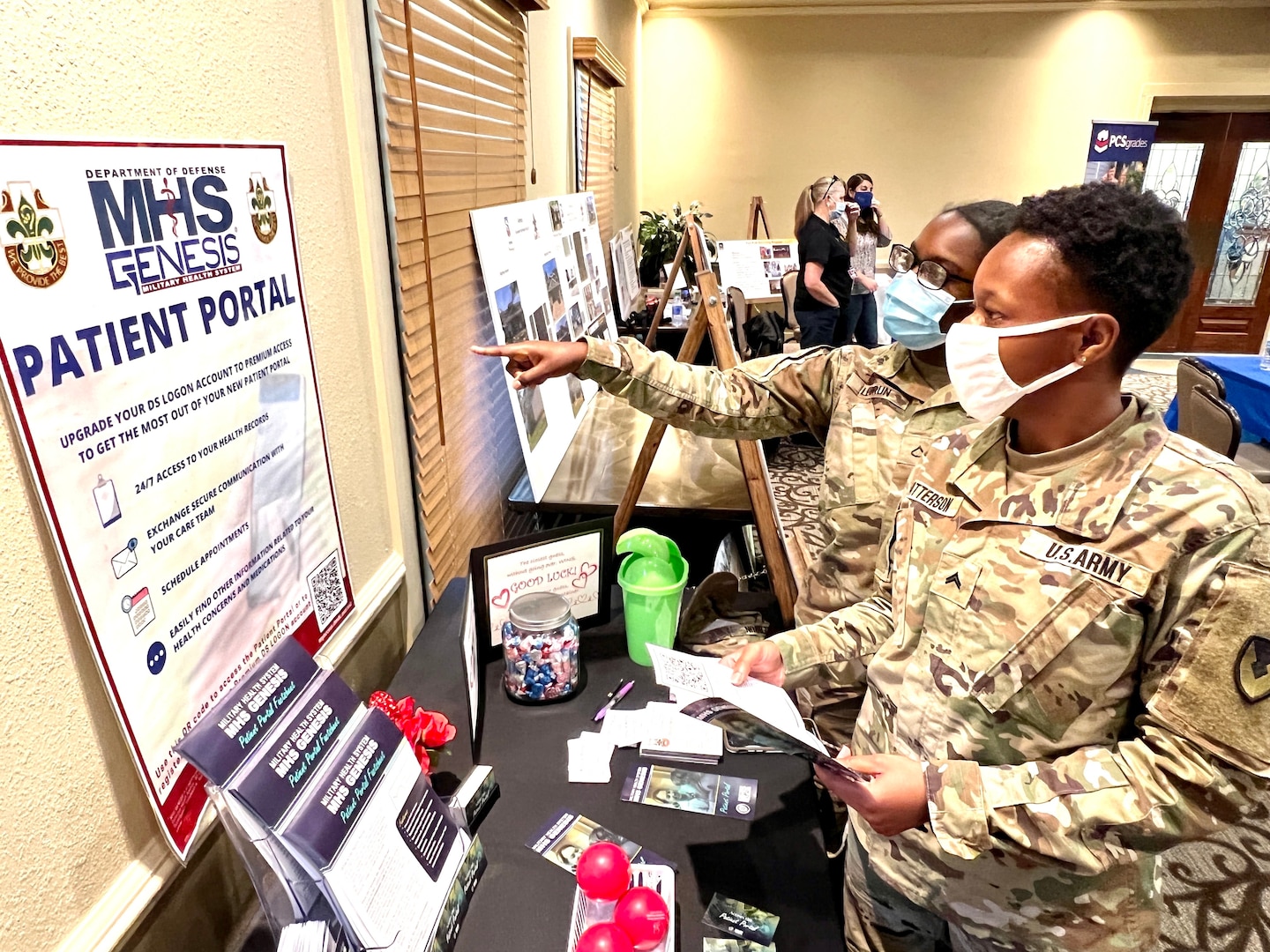 Pvt. 1st Class Guyarbenchie Lebrun, vice president of the Fort Polk Better Opportunities for Single Soldiers Program points out how to access the MHS GENESIS to Cpl. Toymeisha Patterson, BOSS president, on Feb. 9 at the Joint Readiness Training Center and Fort Polk Quality of Life conference.