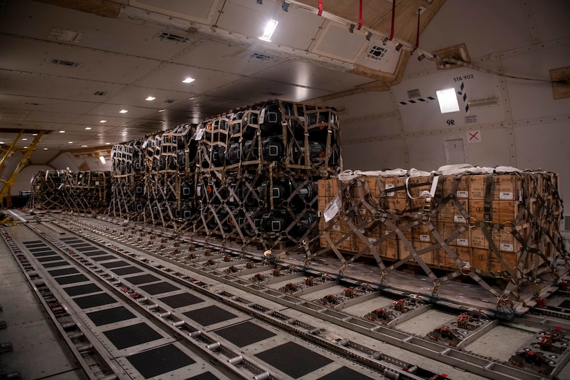 Pallets of ammunition, weapons and other equipment bound for Ukraine are loaded on a plane by the 436th Aerial Port Squadron during a foreign military sales mission at Dover Air Force Base, Delaware,  Jan. 24, 2022.