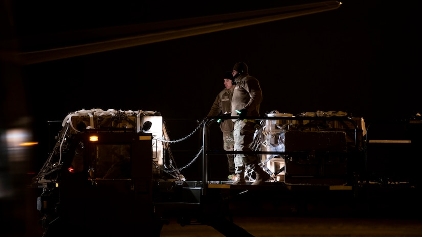 Airmen from the 436th Aerial Port Squadron load ammunition, weapons and other equipment bound for Ukraine during a foreign military sales mission at Dover Air Force Base, Delaware, Jan. 24, 2022.