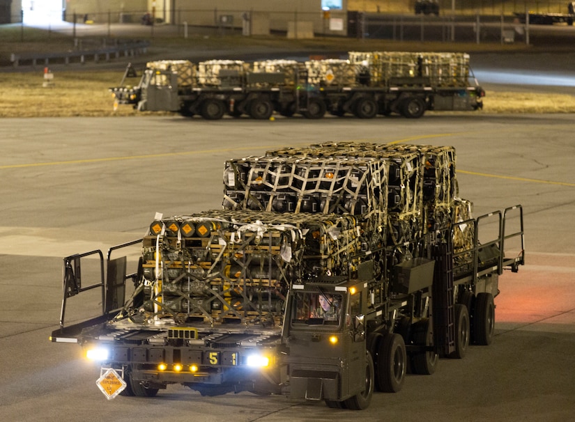 Airman 1st Class Stephen Knotts, 436th Aerial Port Squadron ramp services apprentice, drives a cargo loader with palletized ammunition, weapons and other equipment bound for Ukraine during a foreign military sales mission at Dover Air Force Base, Delaware, Jan. 24, 2022.