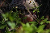 Side profile of a U.S. Marine wearing a high cut enhanced combat helmet in the jungle.