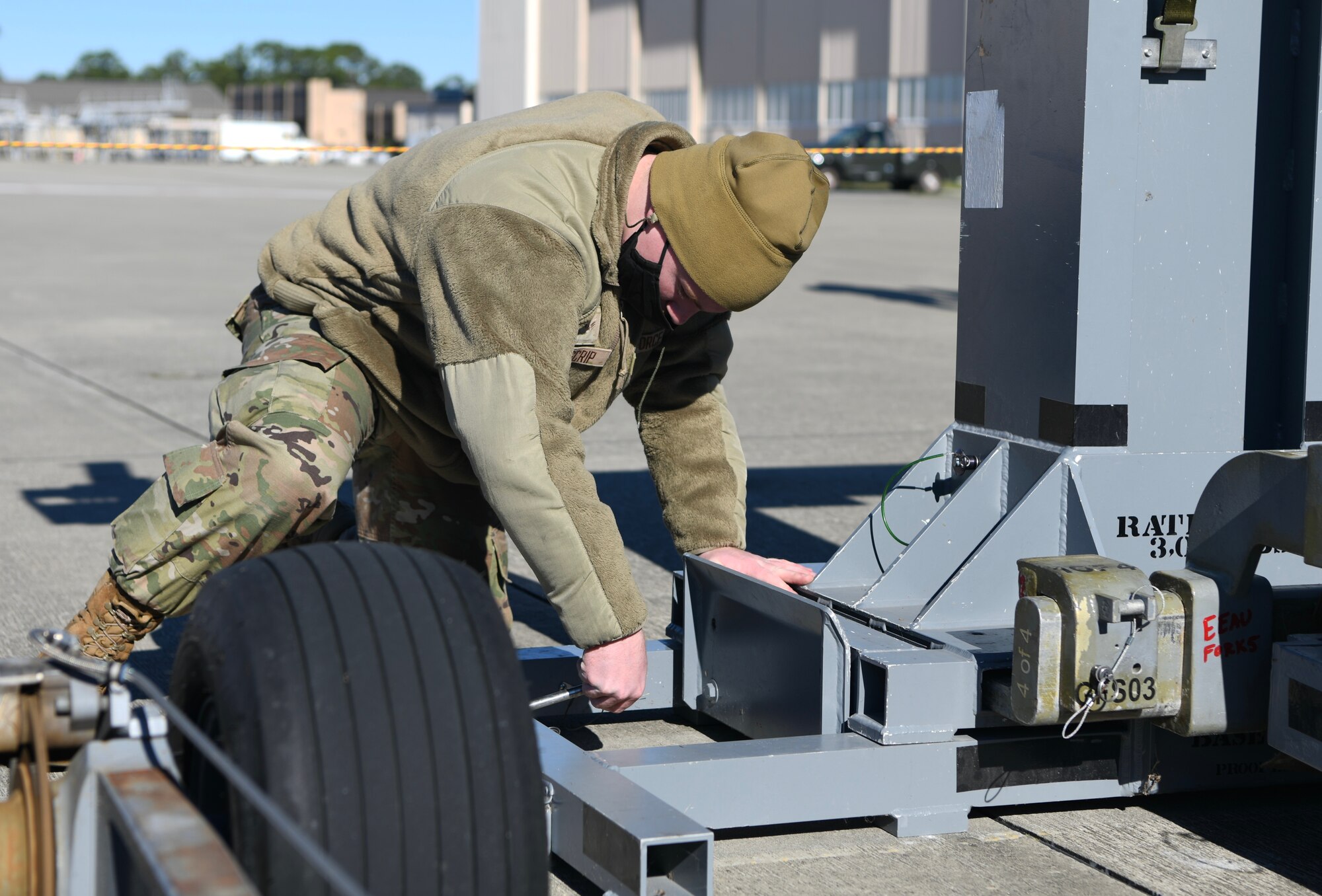U.S. Air Force Airman 1st Class Trevor Moscrip, 4th Aircraft Maintenance Unit weapons load crew member, secures the weapons rack of a trainer BRU-61 bomb during the 1st Special Operations Wing’s Weapons Load Crew of the 4th Quarter Competition Jan. 7, 2022 on the flightline at Hurlburt Field, Florida.