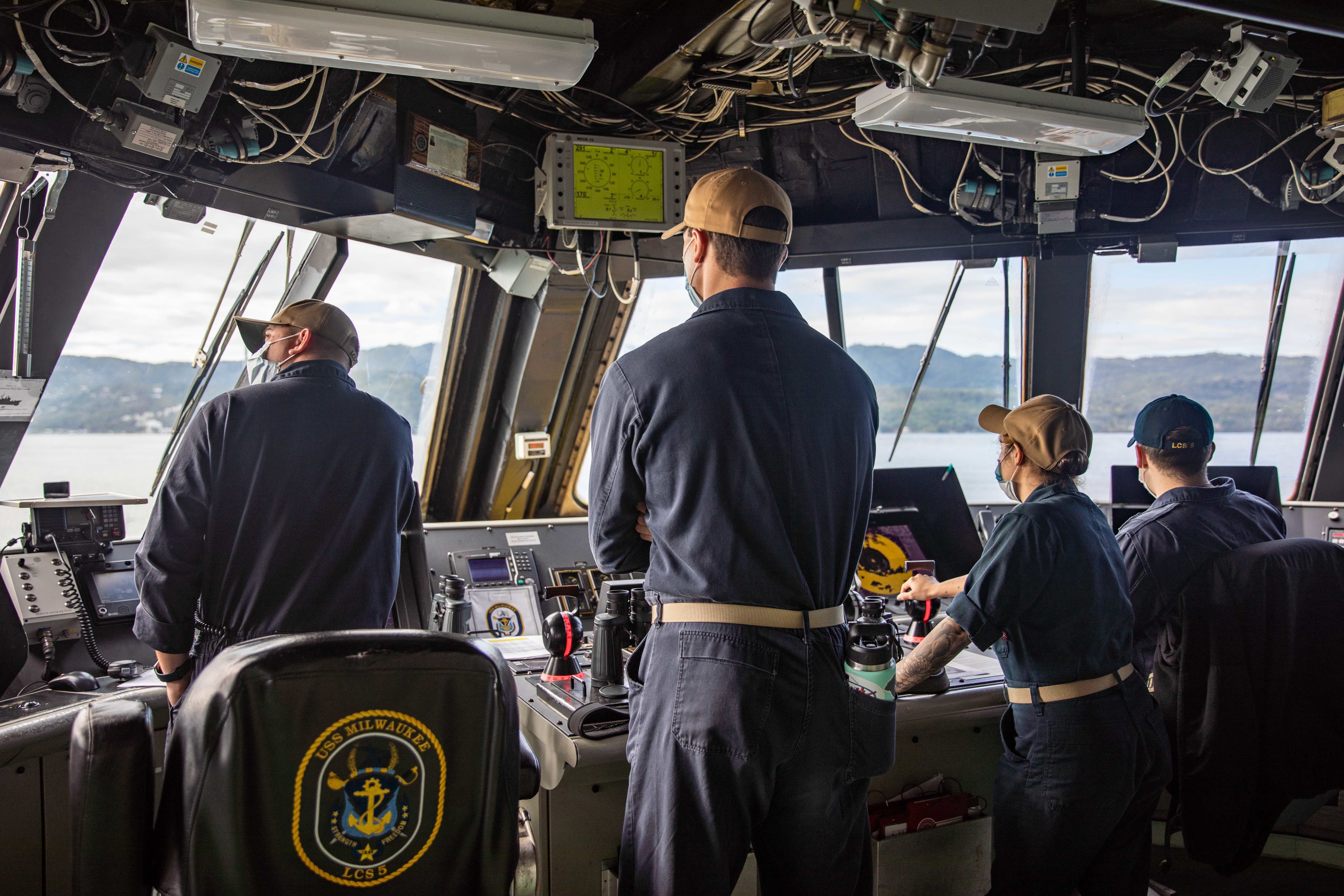 Sailors stand watch in the pilothouse of the Freedom-variant littoral combat ship USS Milwaukee (LCS 5) as the ship arrives in Ocho Rios, Jamaica, for a brief stop for fuel and provisions, Feb. 8, 2022.