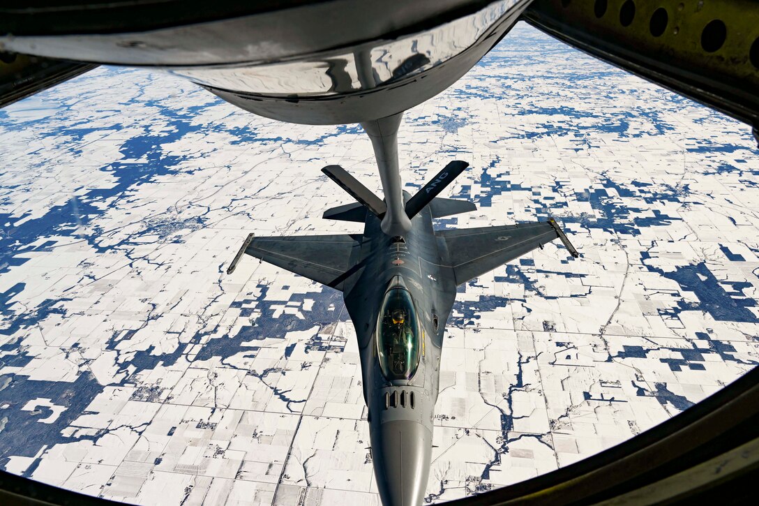 An aircraft refuels in the air with another aircraft.