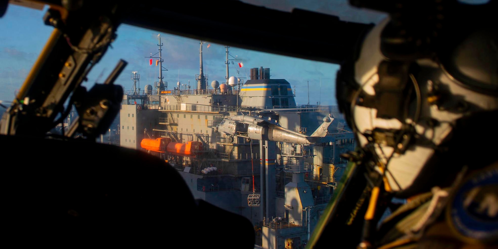 An MH-60S Knight Hawk helicopter, attached to Helicopter Sea Combat Squadron (HSC) 5, receives ammunition from the dry cargo and ammunition ship USNS Medgar Evers (T-AKE 13), Feb. 4, 2022.