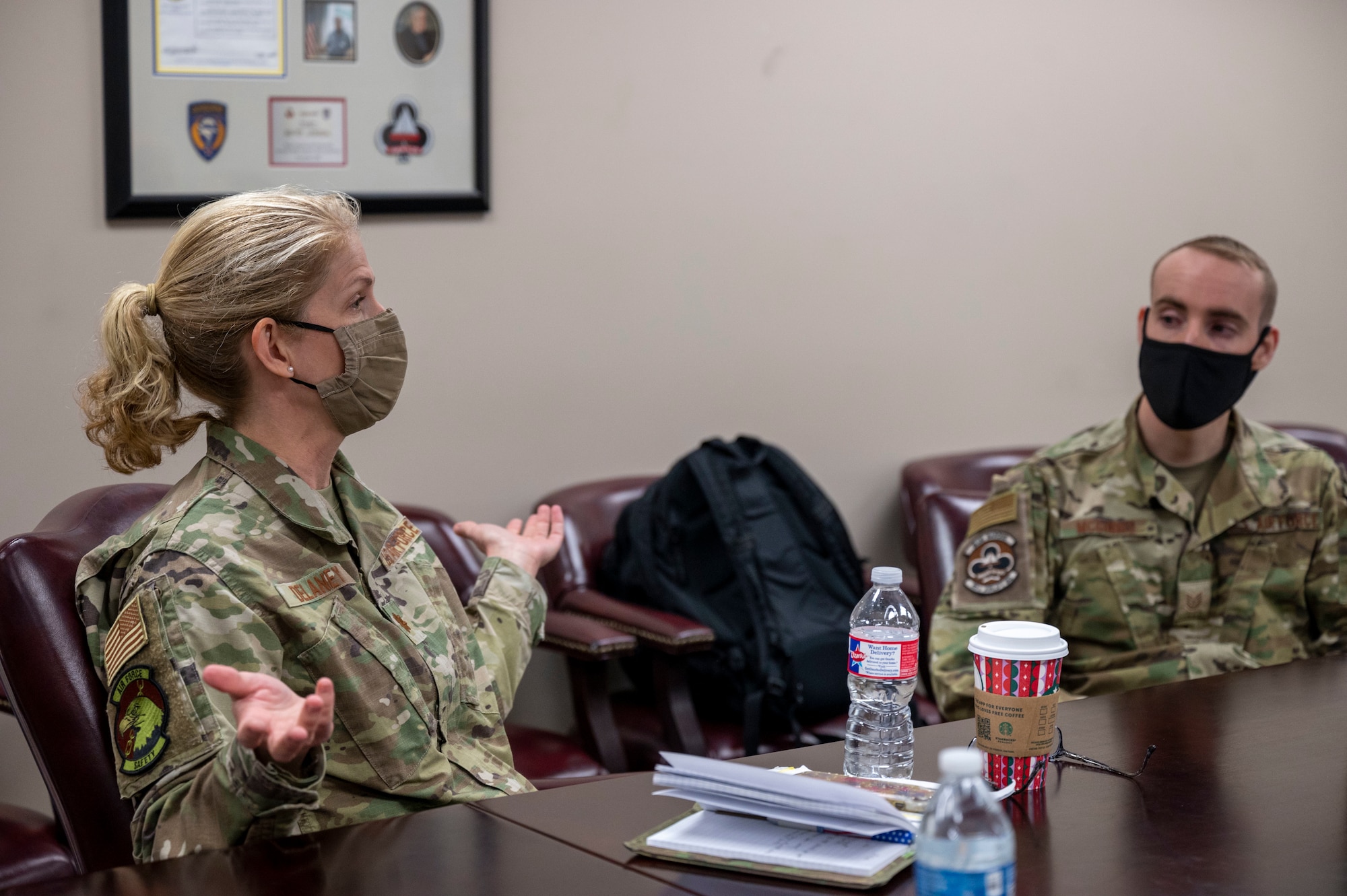 Airmen talk at table