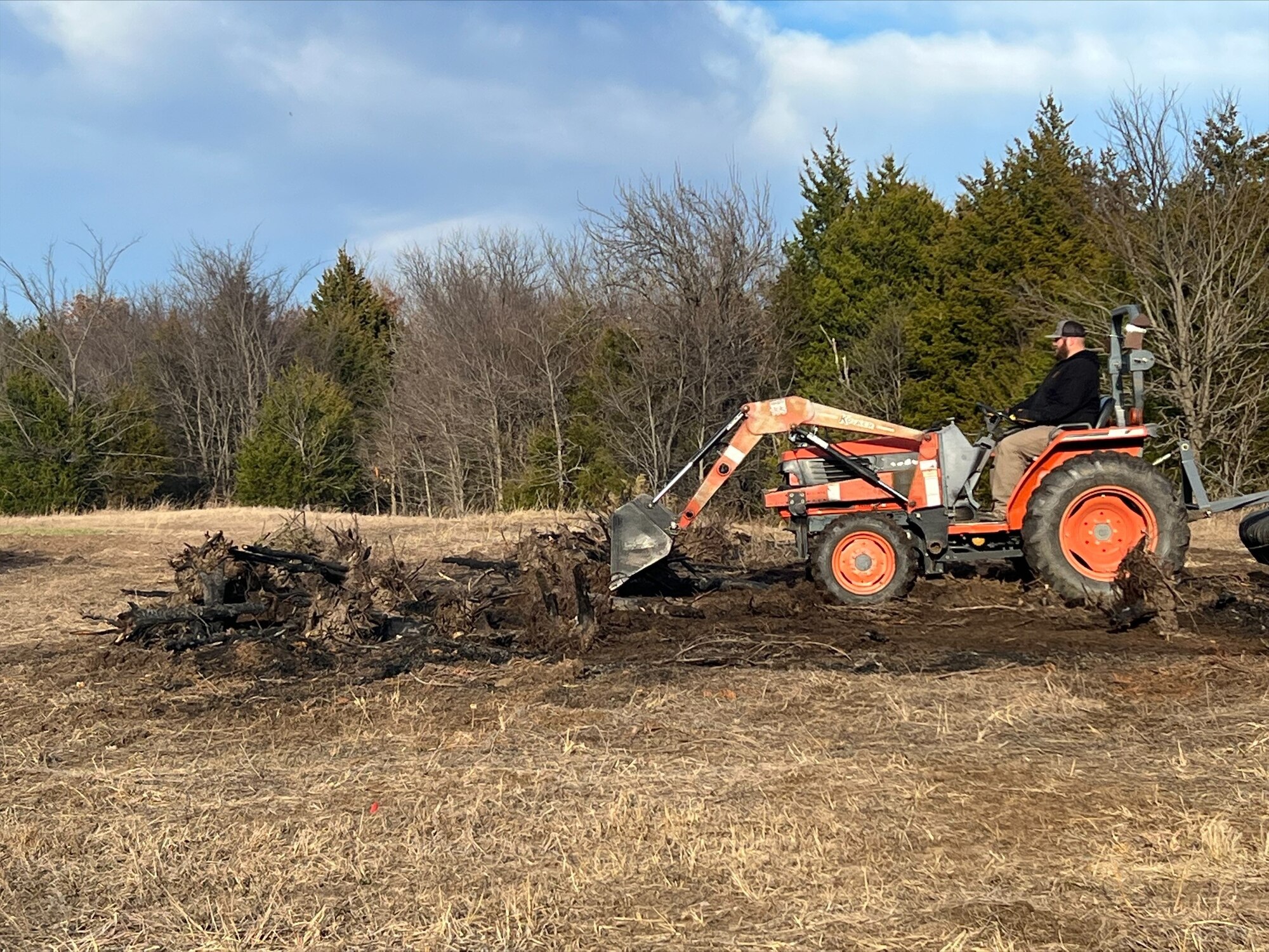 Randall, boyfriend of Legacy Tankers Division FMS Chief Katie Ward, clears land at the couple's ranch. Courtesy photo.