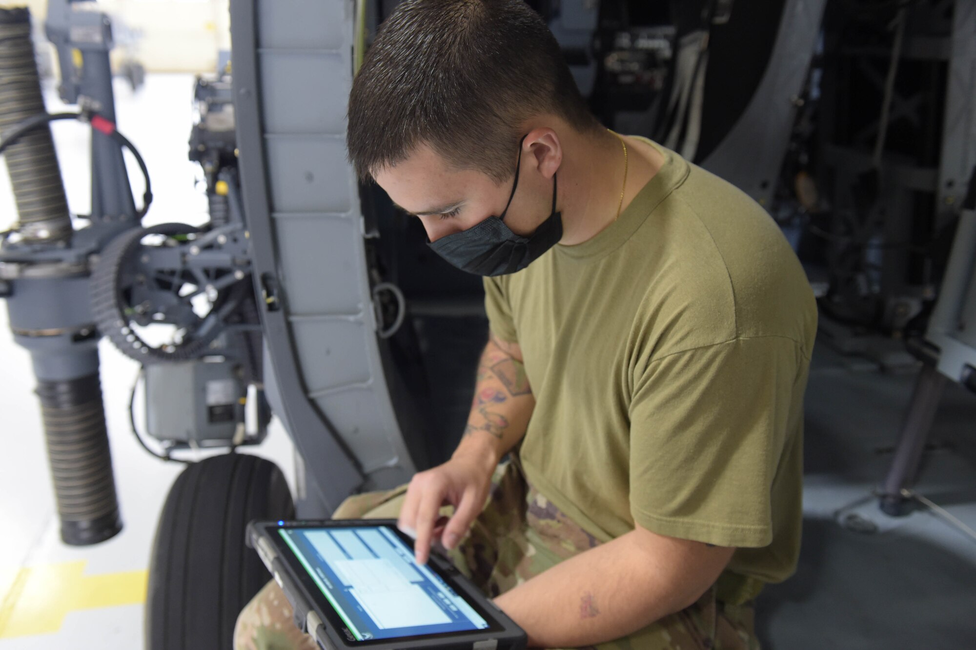 A photo of an Airman working on tablet.