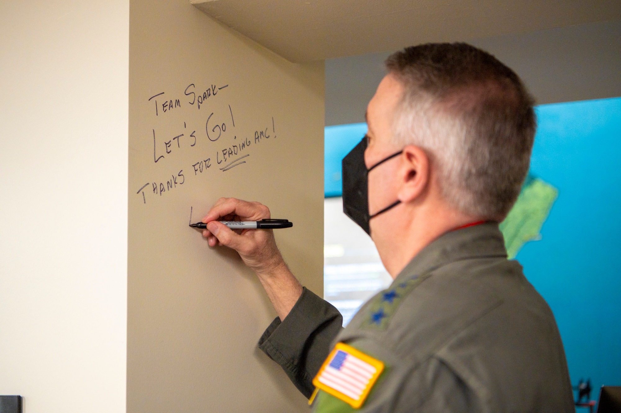 A man writes on a wall