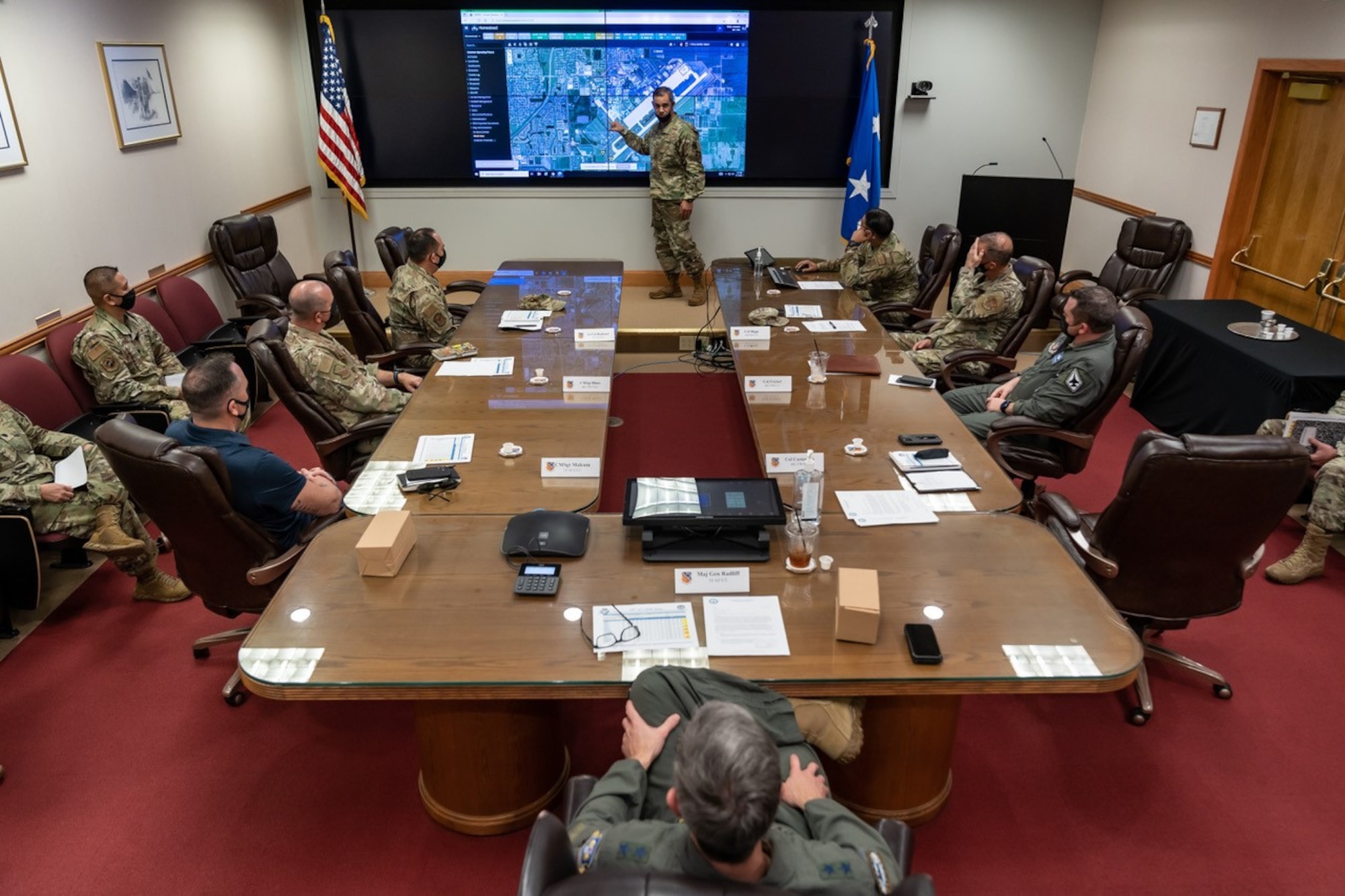 Col. David Castaneda, 482nd FW commander, provides a briefing to Maj. Gen. Bryan Radliff, 10th Air Force commander, and Chief Master Sgt. Jeremy Malcom, 10th Air Force command chief, at Homestead Air Reserve Base, Florida, Feb. 7, 2022. Radliff toured HARB meeting its members. (U.S. Air Force photo by Tech. Sgt. Lionel Castellano)