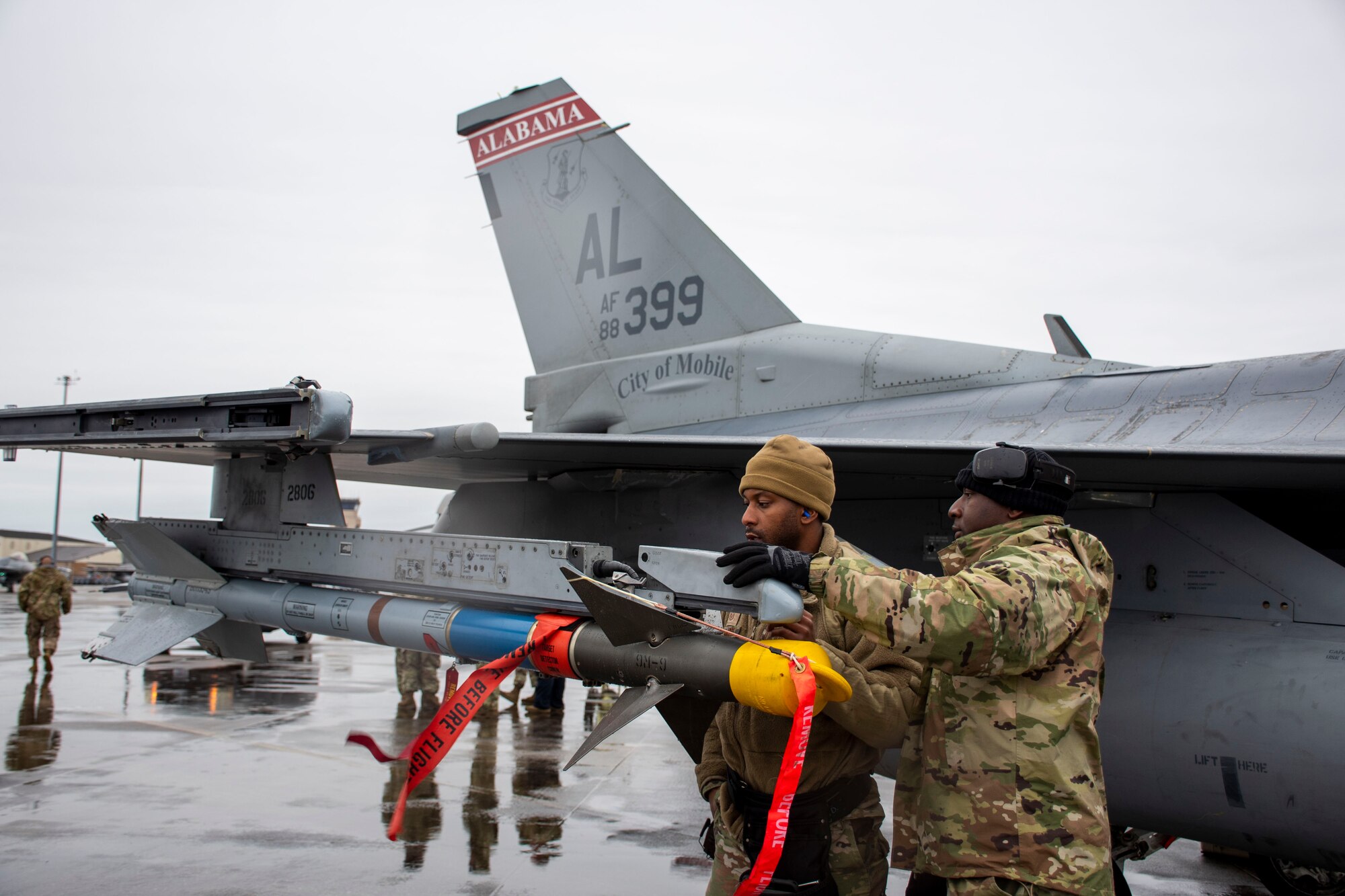 Maintainers assigned to the 100th Fighter Squadron, Dannelly Field, Alabama load an AIM-9 Sidewinder on to a U.S. Air Force F-16C Fighting Falcon “Red Tail” as part of the 53rd Weapons Evaluation Group’s Weapons System Evaluation Program East 22.04, hosted at Tyndall Air Force Base, Florida, Jan. 25, 2022. WSEP tests and validates the performance of crews, pilots, and their technology to enhance readiness for real-world operations. (U.S. Air Force photo by 1st Lt Lindsey Heflin)