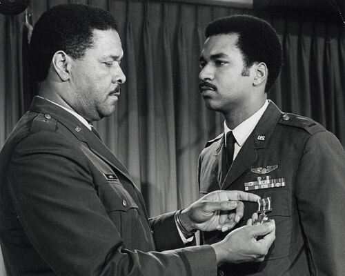 Air Force Lt. Gen. Daniel James III receives the Distinguished Flying Cross from his father, Air Force Gen. Daniel "Chappie" James Jr.