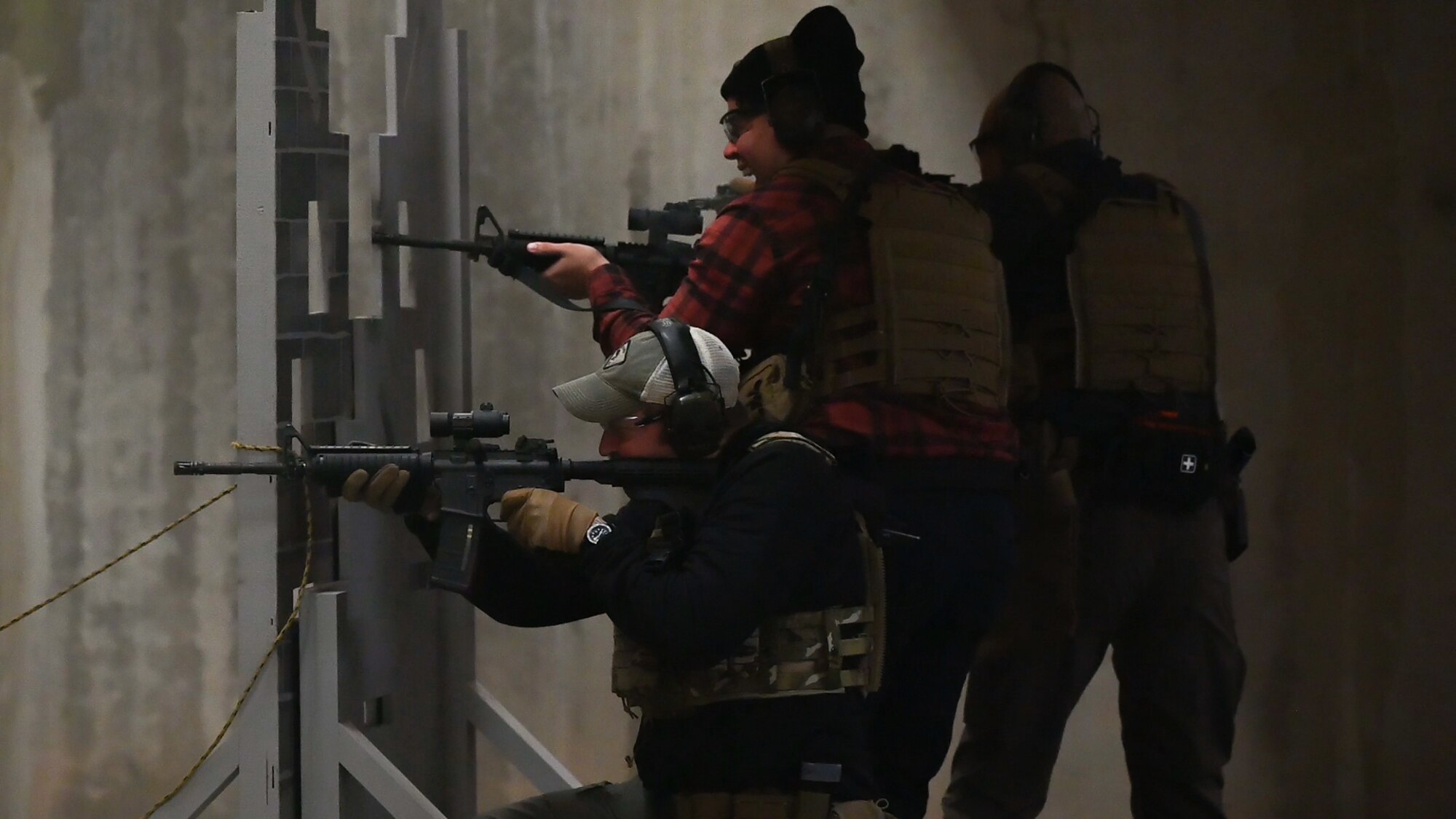 Law enforcement individuals holding weapons.