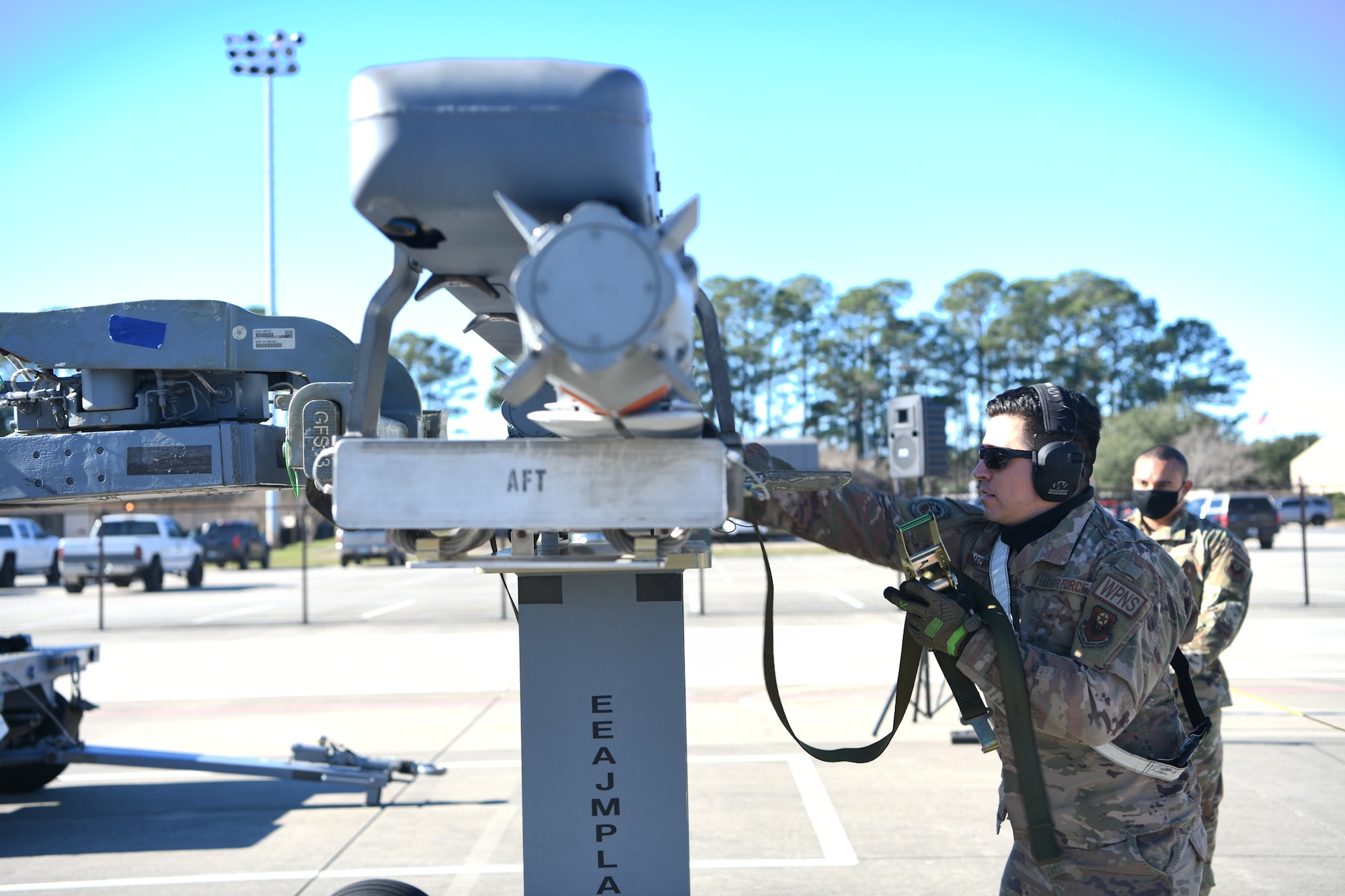 U.S. Air Force Staff Sgt. Daniel Buruato, 4th Aircraft Maintenance Unit weapons load crew members, prepares to secure a trainer BRU-61 bomb prior to lifting it off of its storage rack during the 1st Special Operations Wing’s Weapons Load Crew of the 4th Quarter Competition Jan. 7, 2022 on the flightline at Hurlburt Field, Florida.