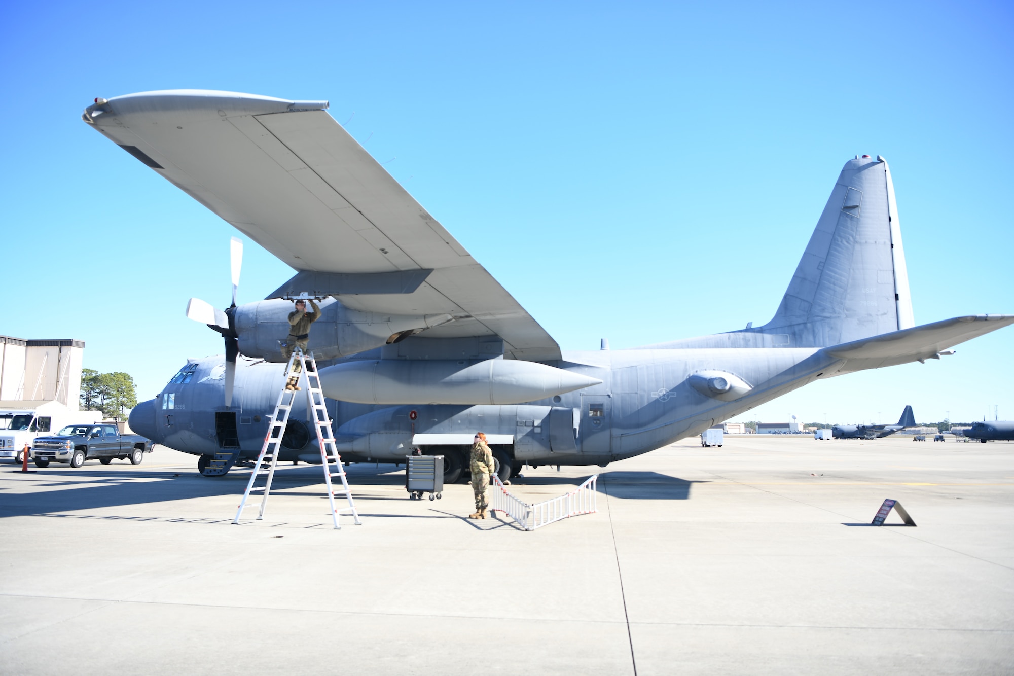 U.S. Air Force Airman 1st Class Kristina Fields, 4th Aircraft Maintenance Unit weapons load crew member, inspects the weapons rack of a AC-130J Ghostrider as U.S. Air Force Senior Airman Rachel Rolling, 1st Special Operations Wing’s Weapons Load Crew of the 4th Quarter Competition evaluator, observes Jan. 7, 2022 on the flightline at Hurlburt Field, Florida.