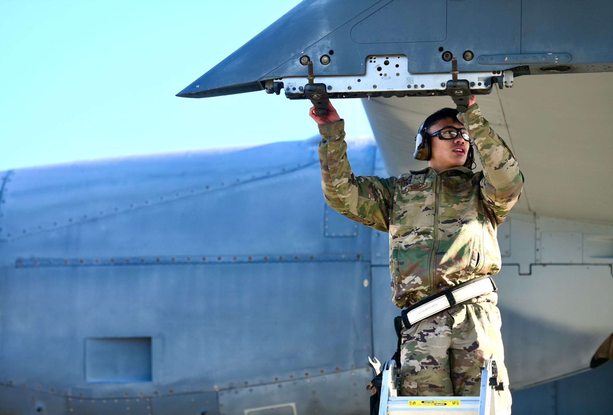 U.S. Air Force SrA Kaipoalohiolamahinap Fukumoto, 73rd Aircraft Maintenance Unit weapons load crew member, inspects the weapons rack of a AC-130J Ghostrider during the 1st Special Operations Wing’s Weapons Load Crew of the 4th Quarter Competition Jan. 7, 2022 on the flightline at Hurlburt Field, Florida.