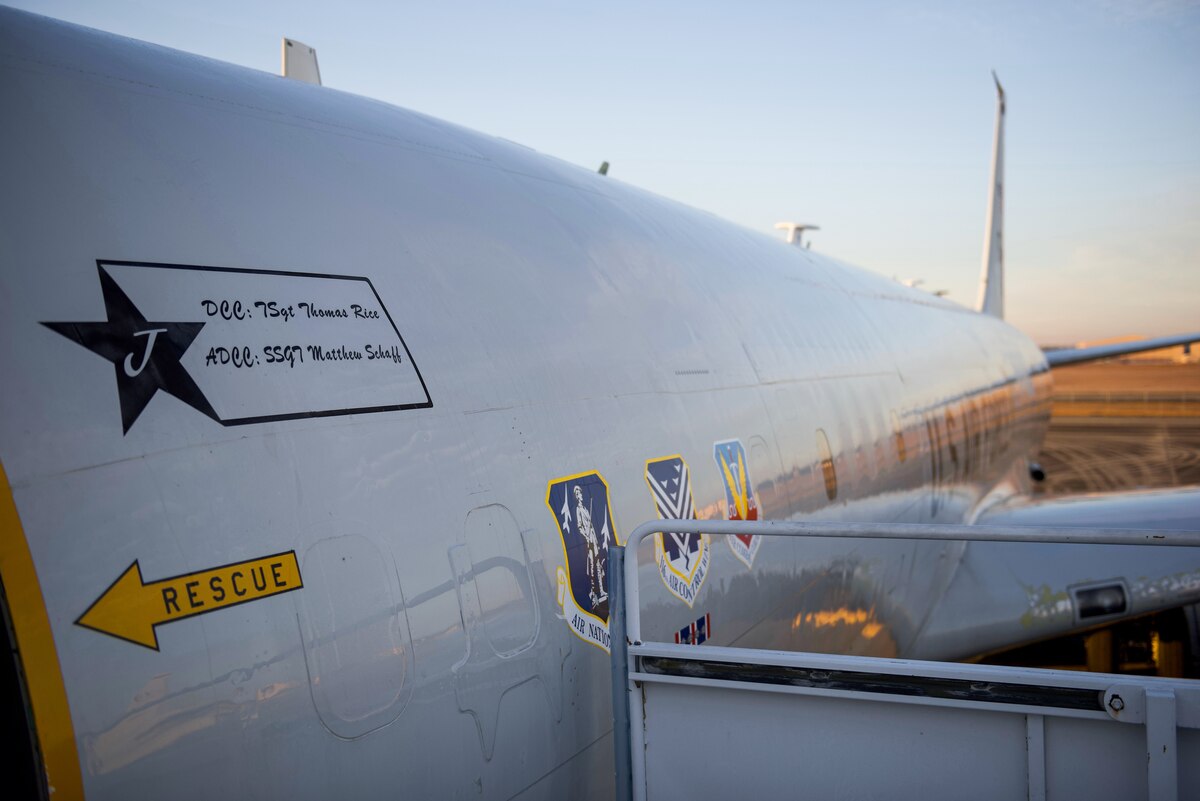 Photo shows a close up of the side of a plane.