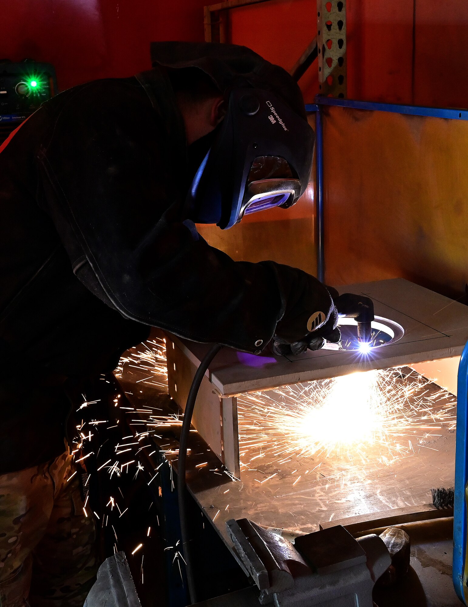 U.S. Air Force Staff Sgt. Luke Gorst, 409th Expeditionary Security Forces Squadron vehicle control officer, uses a plasma cutter to cut a guard tower firing port shield at Nigerien Air Base 201, Agadez, Niger, Feb. 8, 2022. Security forces members developed improvements for the guard towers which included modified firing ports to create a better firing platform and increased field of view for Defenders.  (U.S. Air Force photo by Tech. Sgt. Stephanie Longoria)