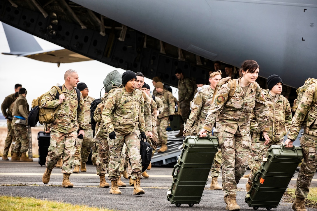 Soldiers exit aircraft.