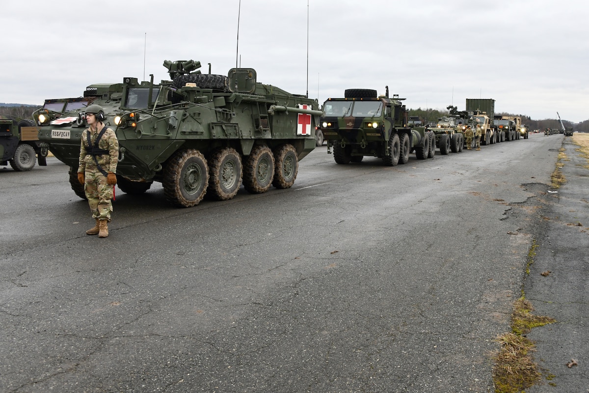 Convoy moves down highway.