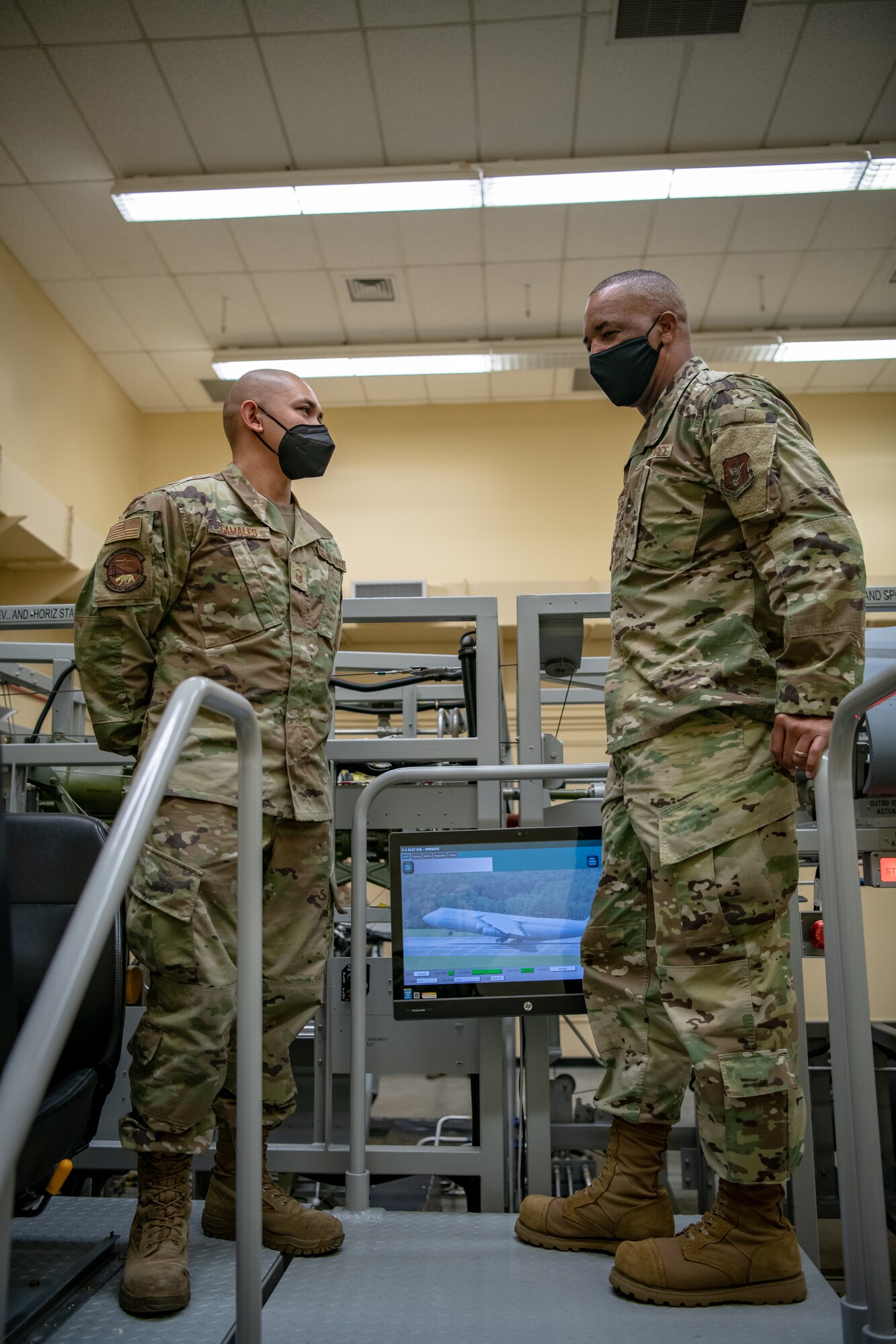 Chief Master Sgt. Timothy C. White Jr., senior enlisted advisor to the chief of Air Force Reserve and command chief of Air Force Reserve Command, chats with Master Sgt. Alexander C. Camales, 349th Aircraft Maintenance Squadron, about his 23 years spent at the base during a visit to Travis Air Force Base, California, Feb. 12, 2022. Camales shared with White how maintainers are utilizing simulators to improve readiness training capabilities.