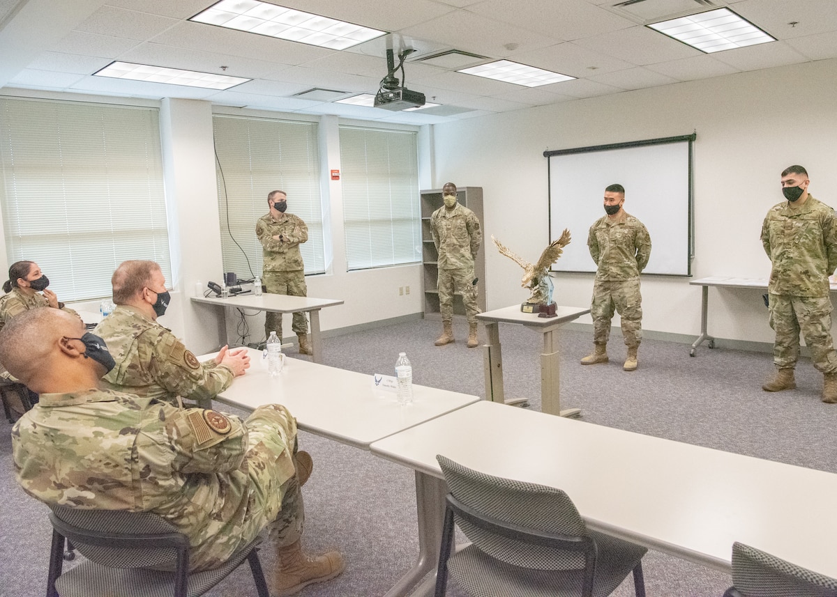 Lt. Gen. Richard W. Scobee, chief of the Air Force Reserve and commander of the Air Force Reserve Command, and Chief Master Sgt. Timothy C. White Jr., senior enlisted advisor to the Chief of Air Force Reserve and command chief of Air Force Reserve Command, learn why the 349th Security Forces Squadron was named the AFRC Large Tenant Unit of the Year during a visit to Travis Air Force Base, California, Feb. 12, 2022. Scobee and White visited the 349th Air Mobility Wing to learn more about its people, mission, accomplishments, and innovation efforts.