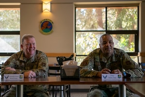 Lt. Gen. Richard W. Scobee, chief of the Air Force Reserve and commander of the Air Force Reserve Command, and Chief Master Sgt. Timothy C. White Jr., senior enlisted advisor to the Chief of Air Force Reserve and command chief of Air Force Reserve Command, have lunch with Airmen at the Monarch Dining Facility at Travis Air Force Base, California, Feb. 12, 2022. The opportunity allowed the 349th Air Mobility Wing to showcase its people, mission, accomplishments, and innovation efforts.