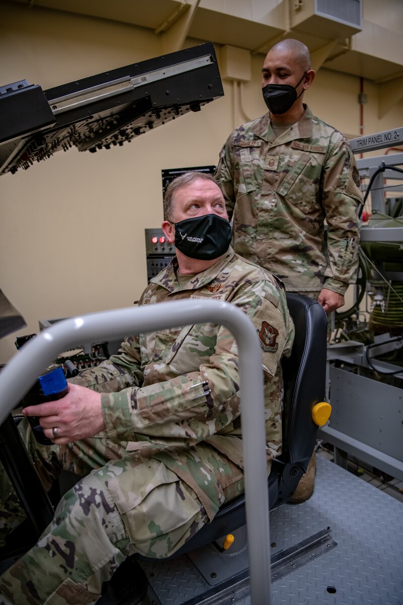 Lt. Gen. Richard W. Scobee, commander of the Air Force Reserve and chief of the Air Force Reserve Command, pilots a training simulator under the guidance of Master Sgt. Alexander C. Camales, 349th Aircraft Maintenance Squadron, at Travis Air Force Base, California, Feb. 12, 2022. Reserve Citizen Airmen maintainers are utilizing such simulators to improve readiness training capabilities.