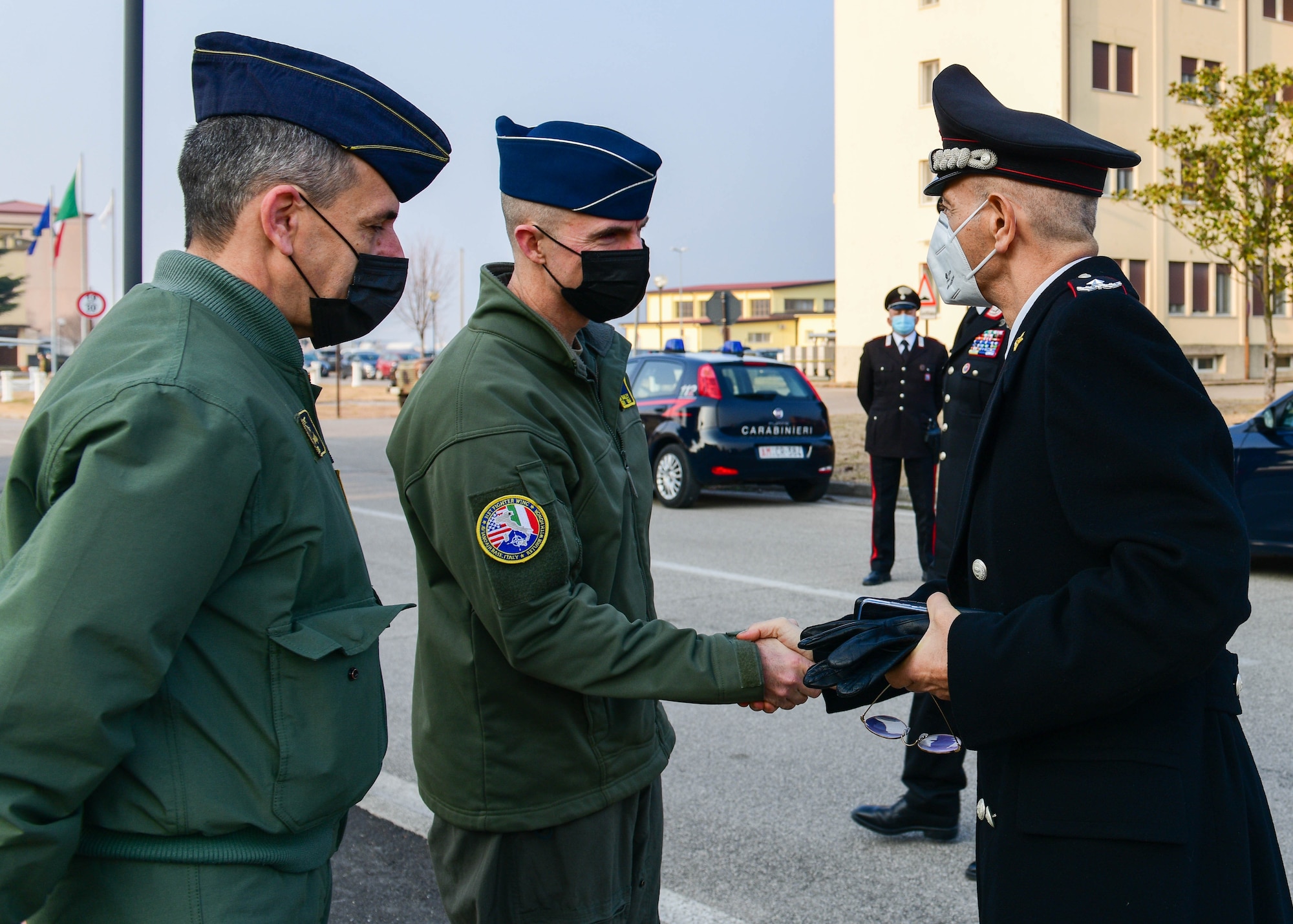 U.S. Air Force Brig. Gen. Jason Bailey, 31st Fighter Wing commander middle, greets Brig. Gen. Francesco Atzeni, Friuli Venezia Giulia Carabinieri commander, Feb. 11, 2022. During the visit, Atzeni toured the 56th Rescue Squadron unit and the Air Control Tower. These visits build relationships and strengthen trusted partnerships between Italy and the United States. (U.S. Air Force photo by Senior Airman Brooke Moeder)