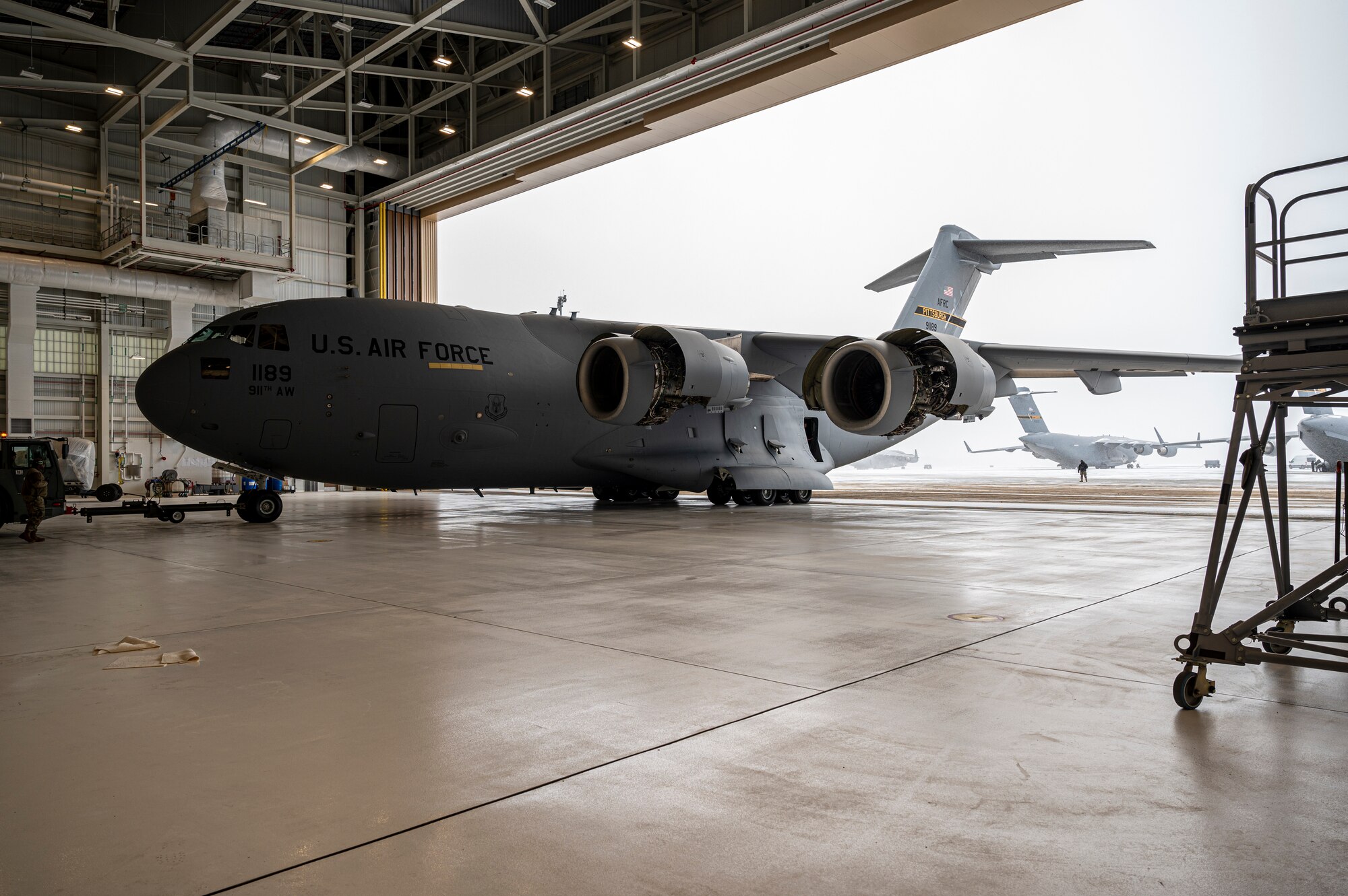 Airmen assigned to the 911th Maintenance Group tow a C-17 Globemaster III at the Pittsburgh International Airport Air Reserve Station, Pennsylvania, Jan. 20, 2022.