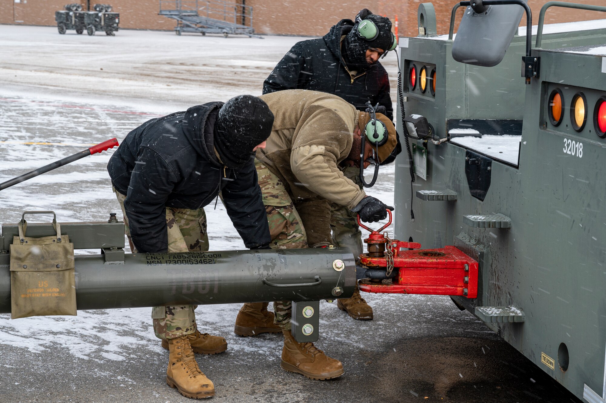 Airmen assigned to the 911th Maintenance Group connect an aircraft tug vehicle to a C-17 Globemaster III at the Pittsburgh International Airport Air Reserve Station, Pennsylvania, Jan. 20, 2022.